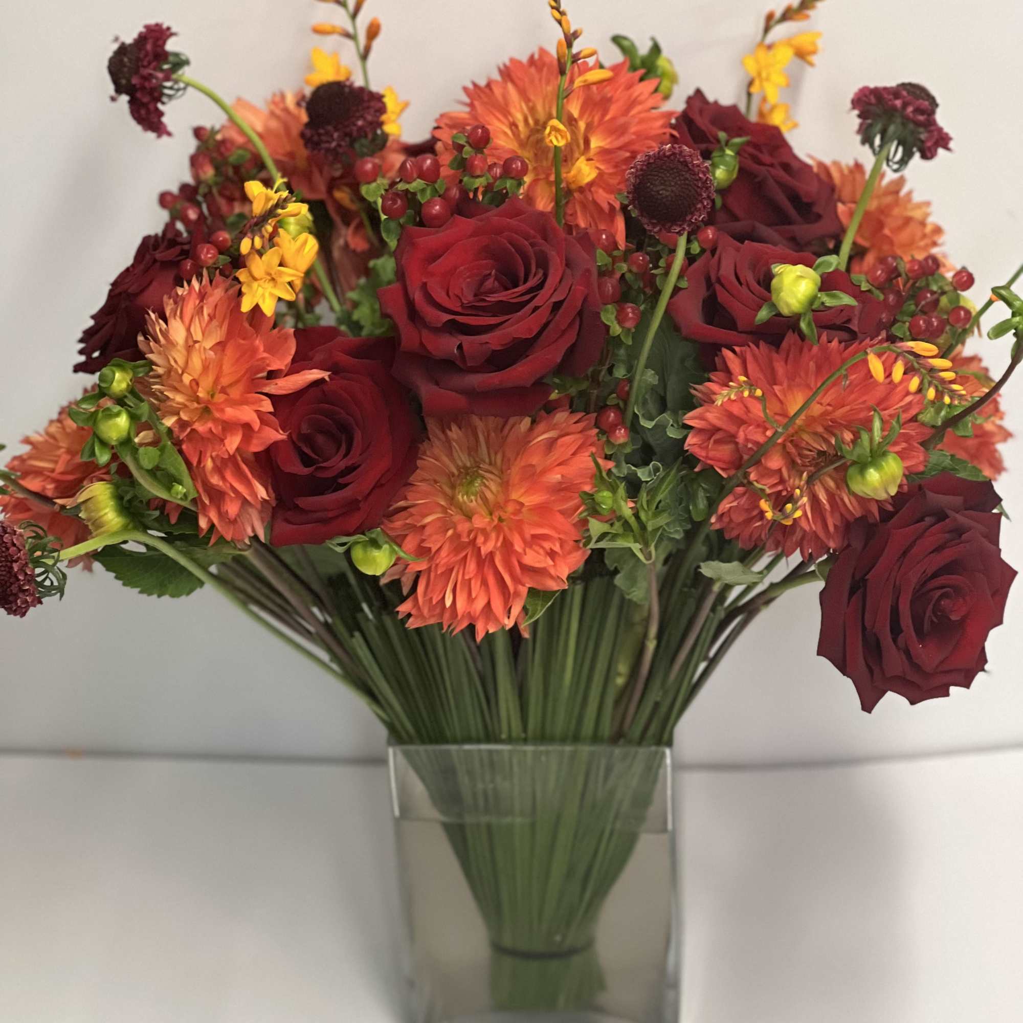 Lush assortment of long stemmed flowers set in a cluster of steel, photo 2 of 6