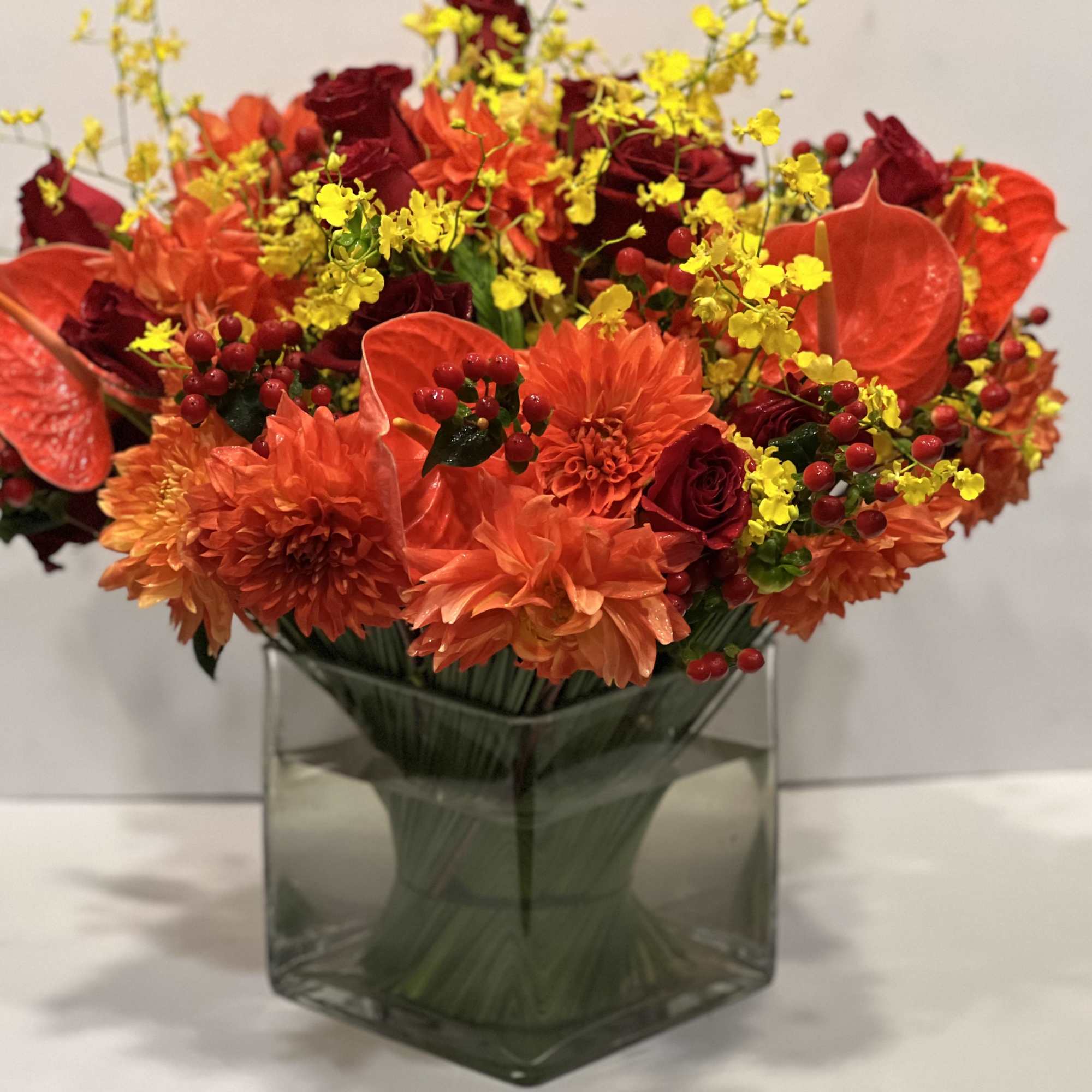 Lush assortment of long stemmed flowers set in a cluster of steel, photo 2 of 6