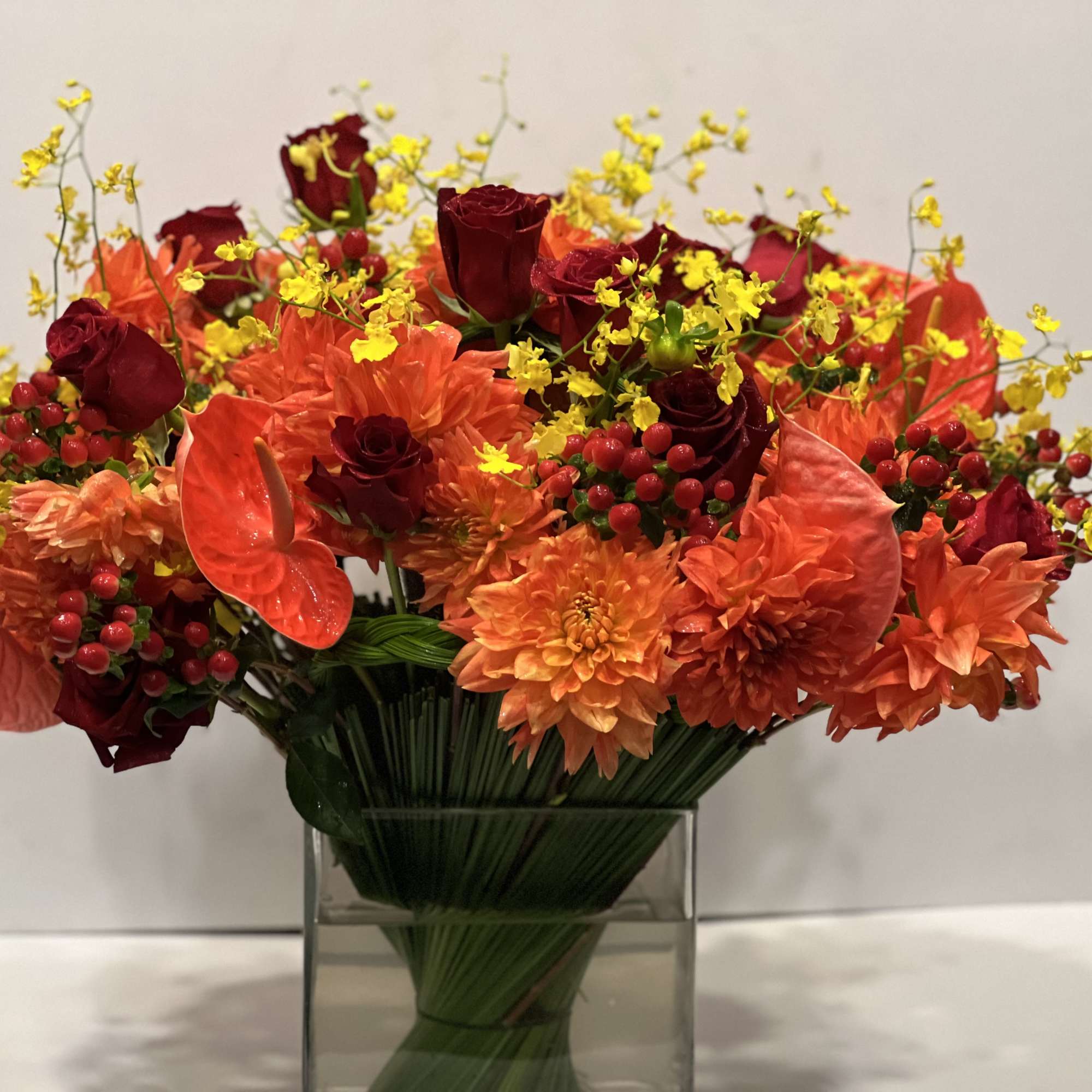 Lush assortment of long stemmed flowers set in a cluster of steel, photo 6 of 6