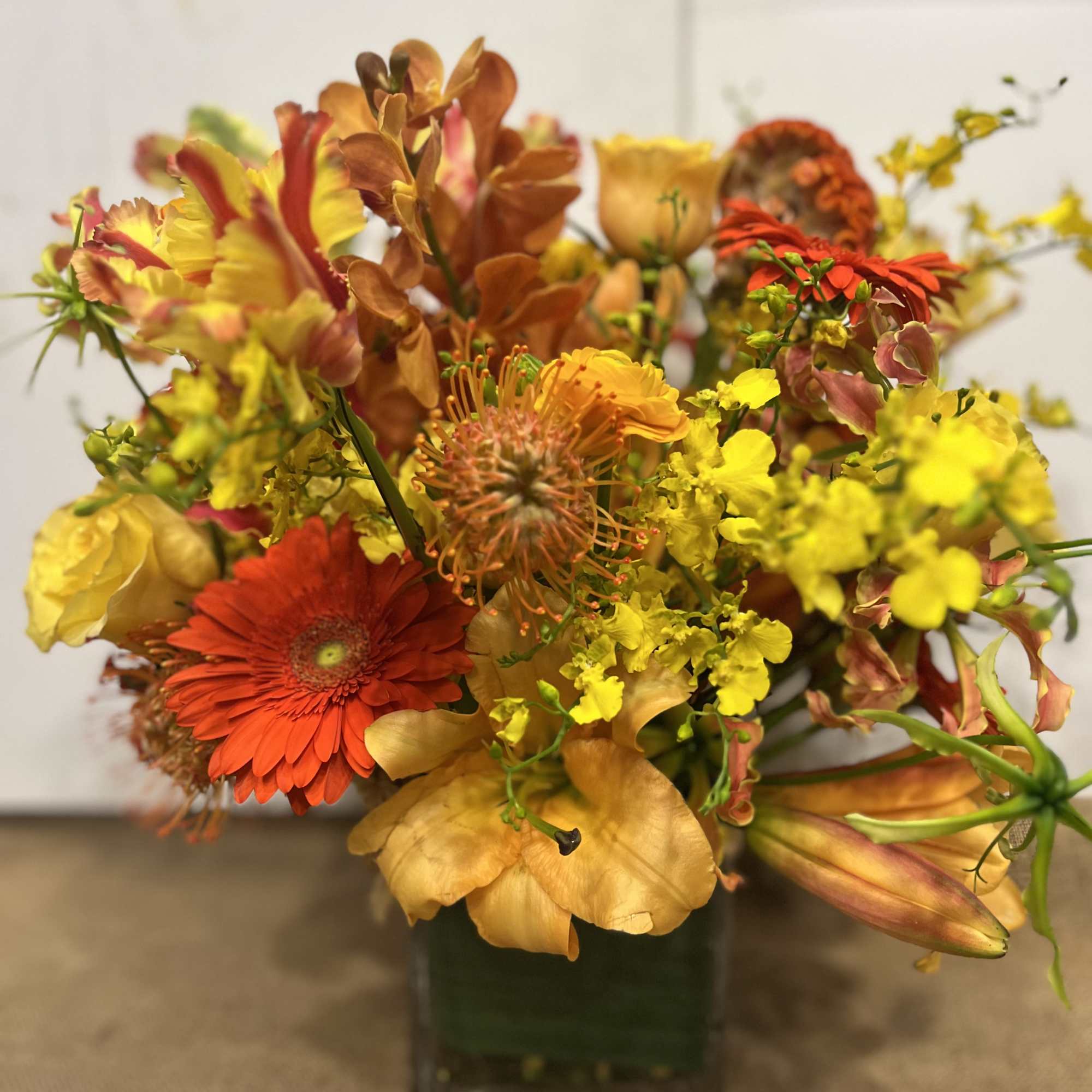 Medium high floral arrangement compose of an assortment of, yellow roses, nutan, photo 4 of 7
