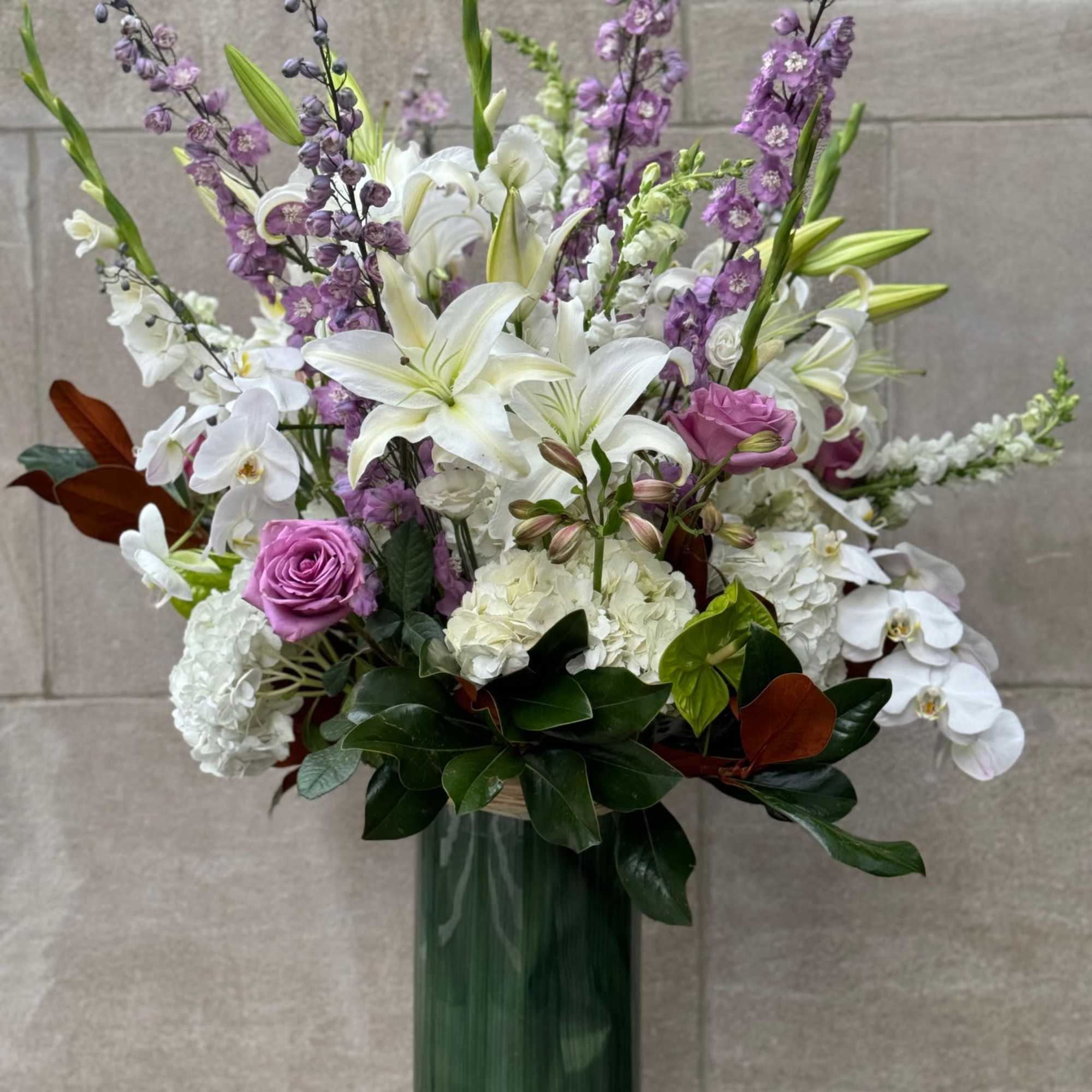 Tall and lush display of flowers features, white hydrangeas, hybrid delphinium, lavender, photo 4 of 6