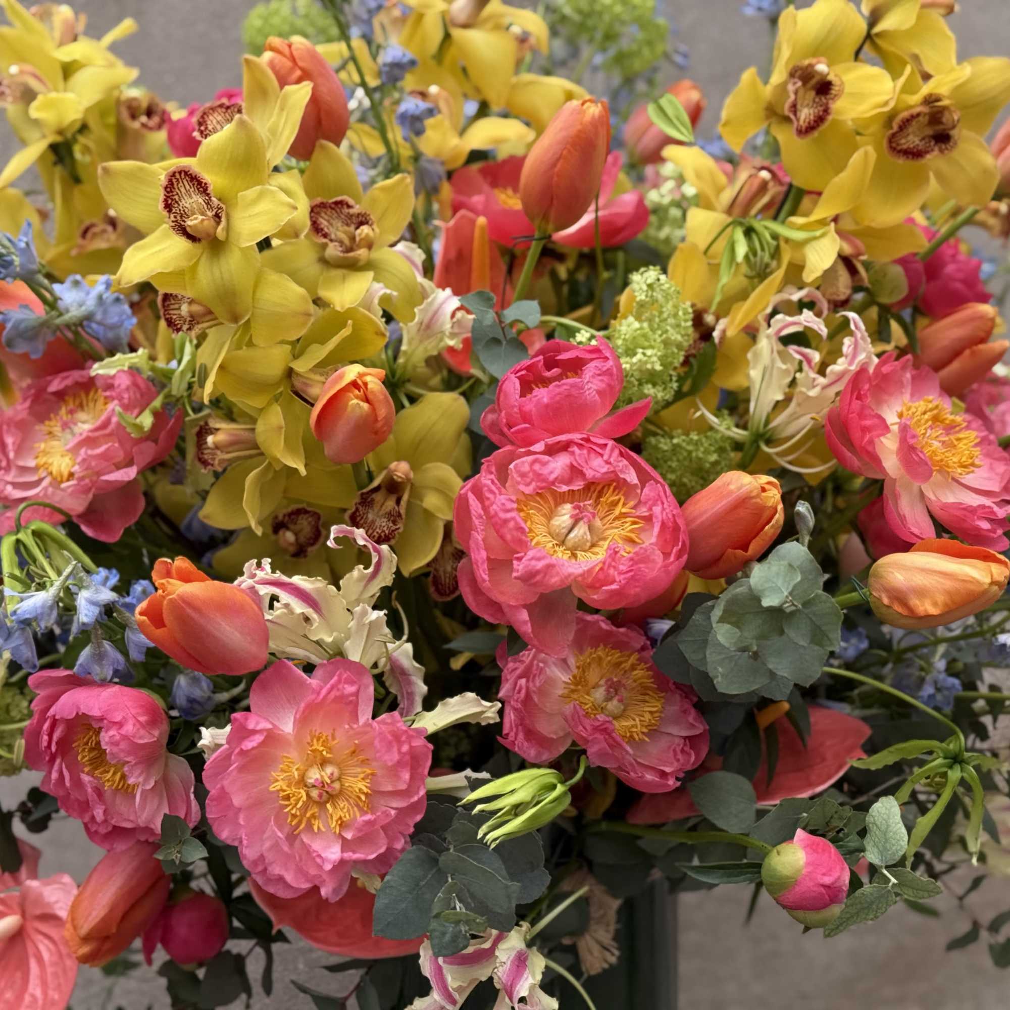 Bouquet of pink and yellow flowers with orange tulips