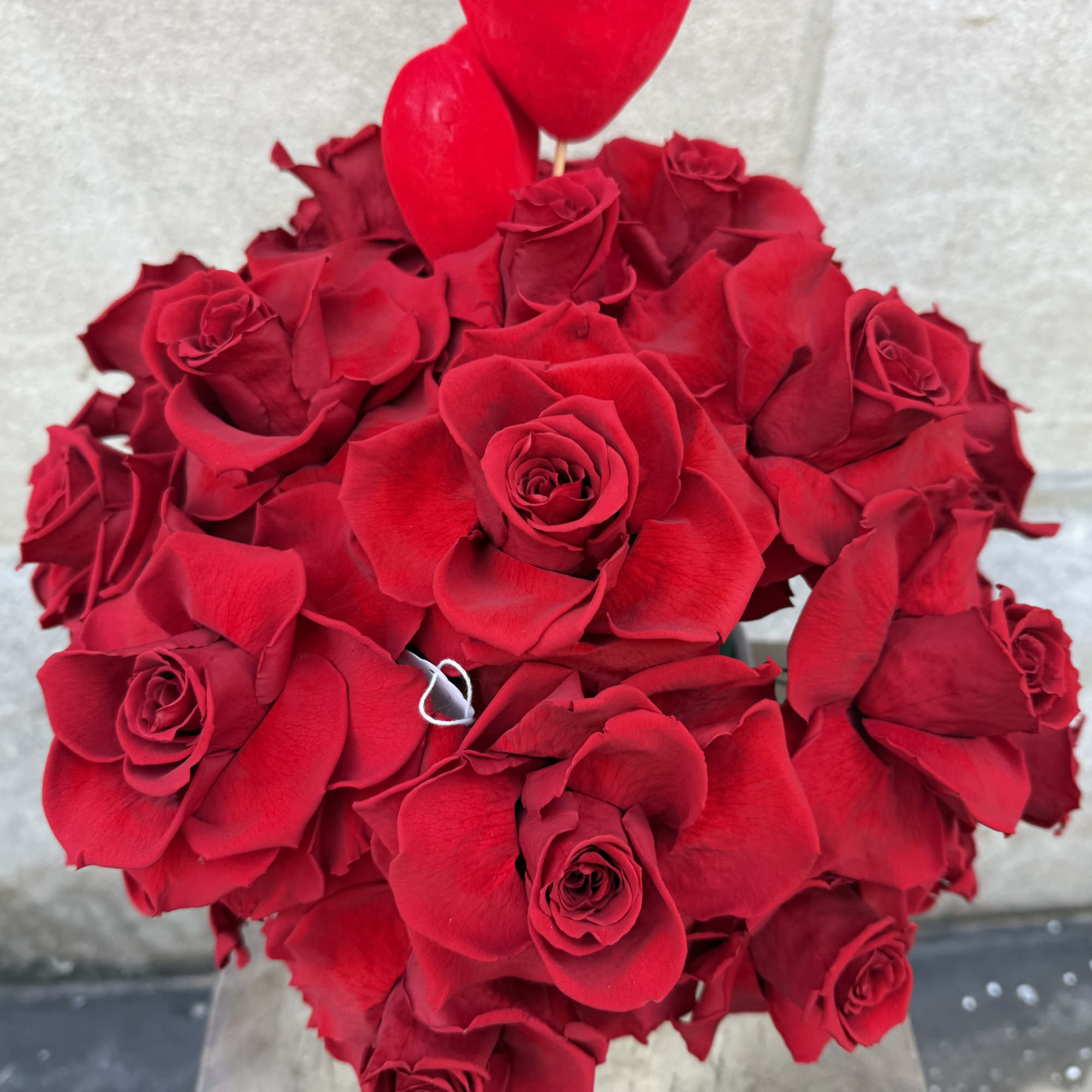 Bouquet of red roses with heart-shaped balloons