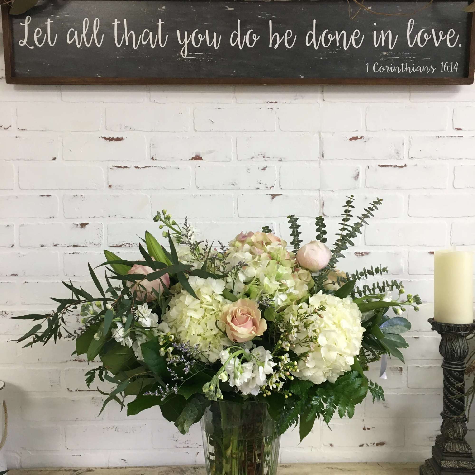 Mixed white and blush flower arrangement in a clear glass vase