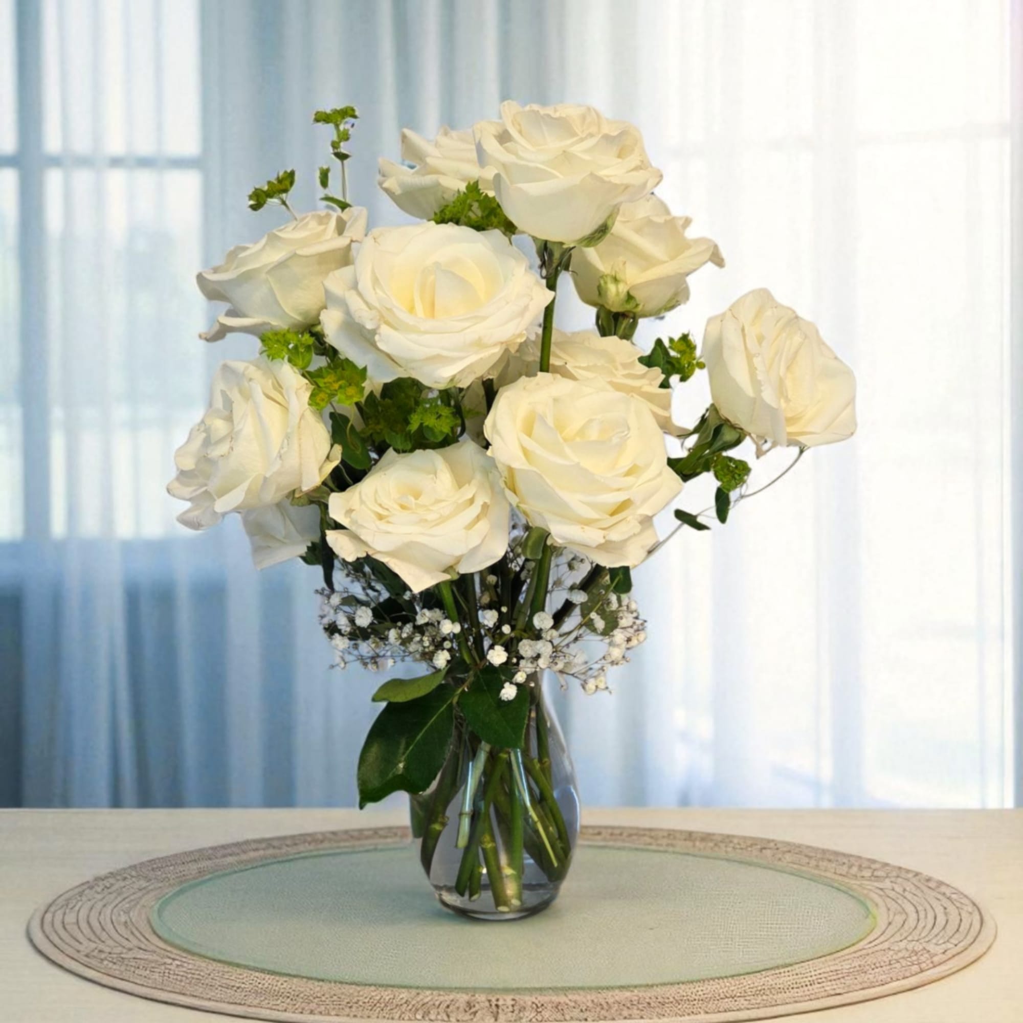 White roses arranged in a clear glass vase