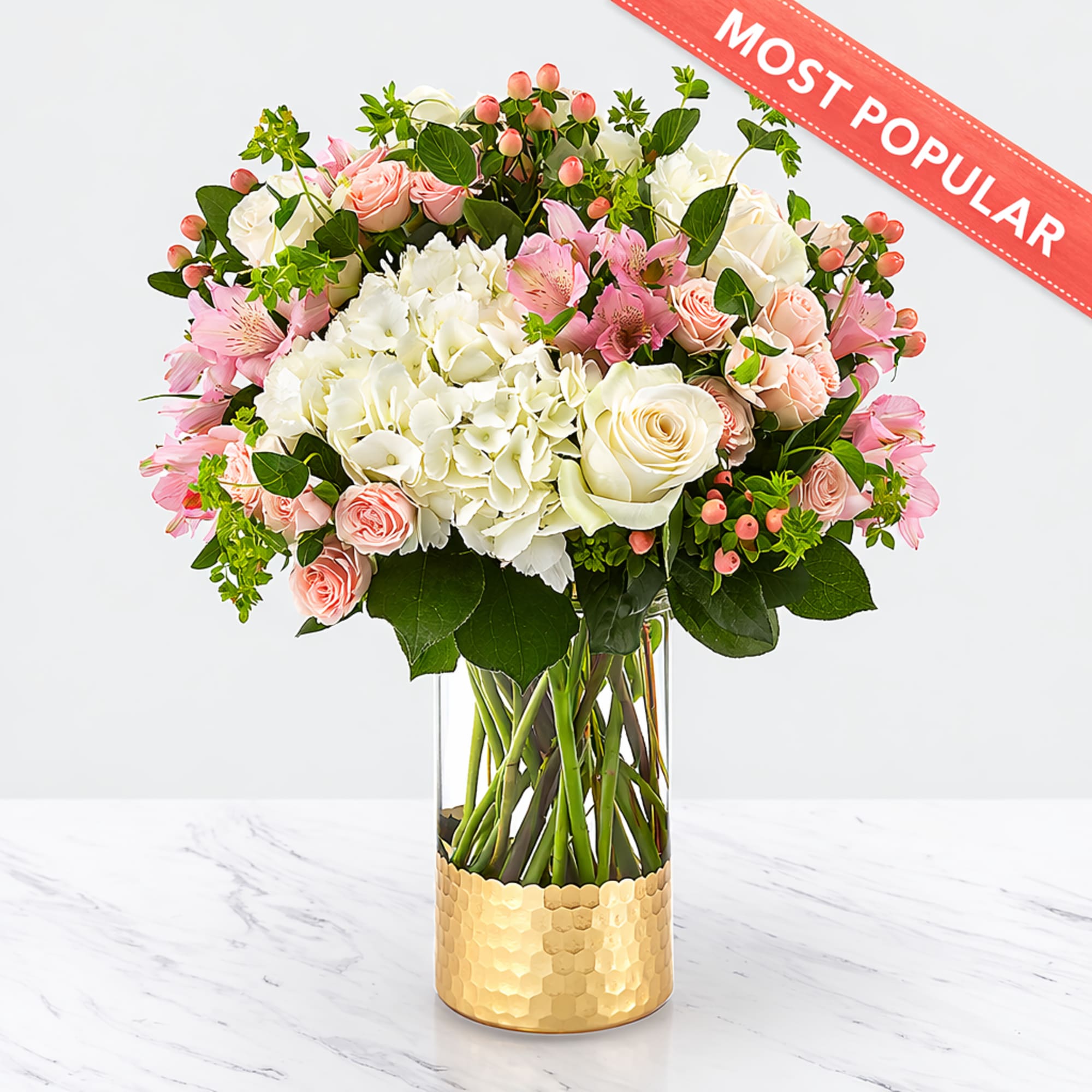 Bouquet of white and pink flowers in a gold vase