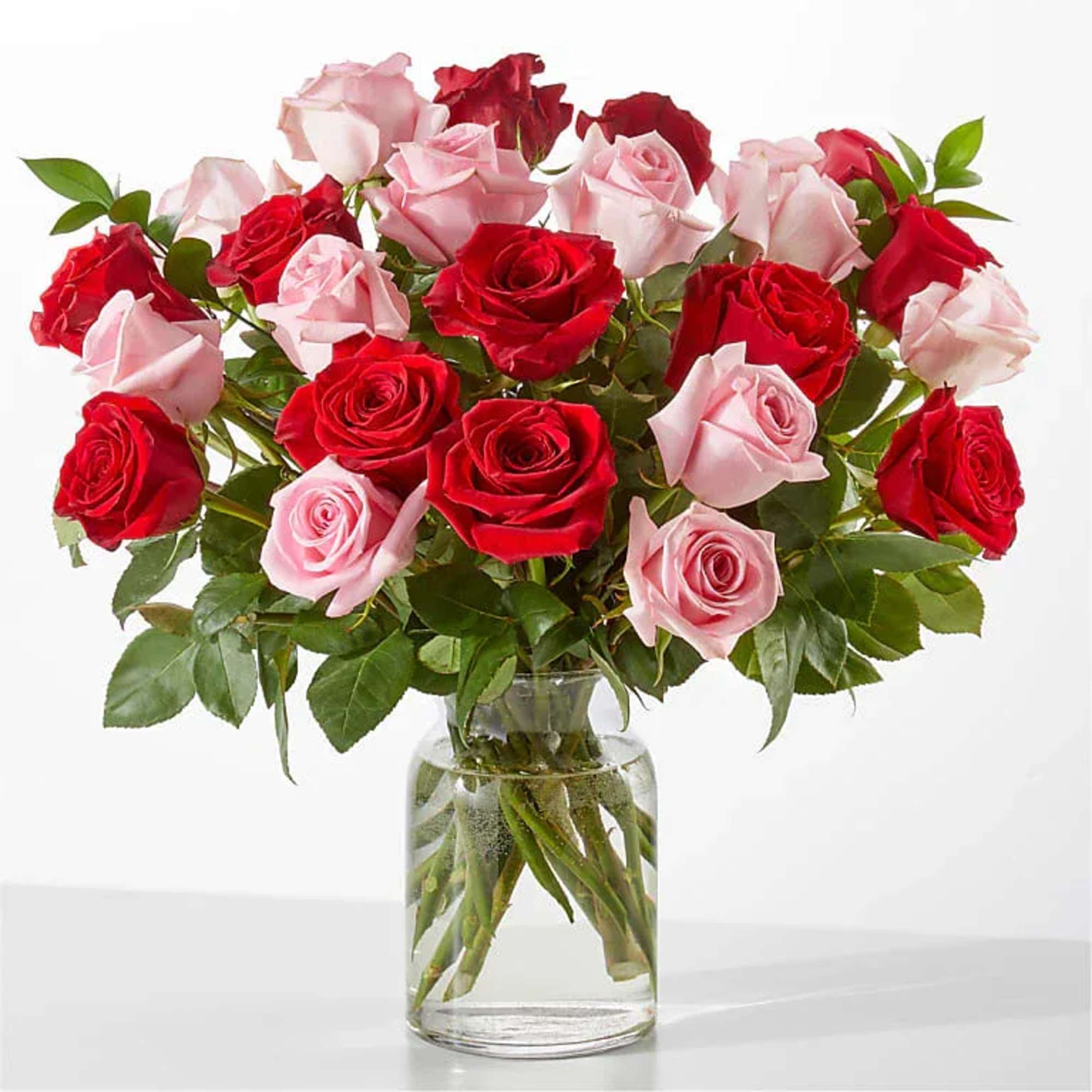 Bouquet of red and pink roses in a clear glass vase