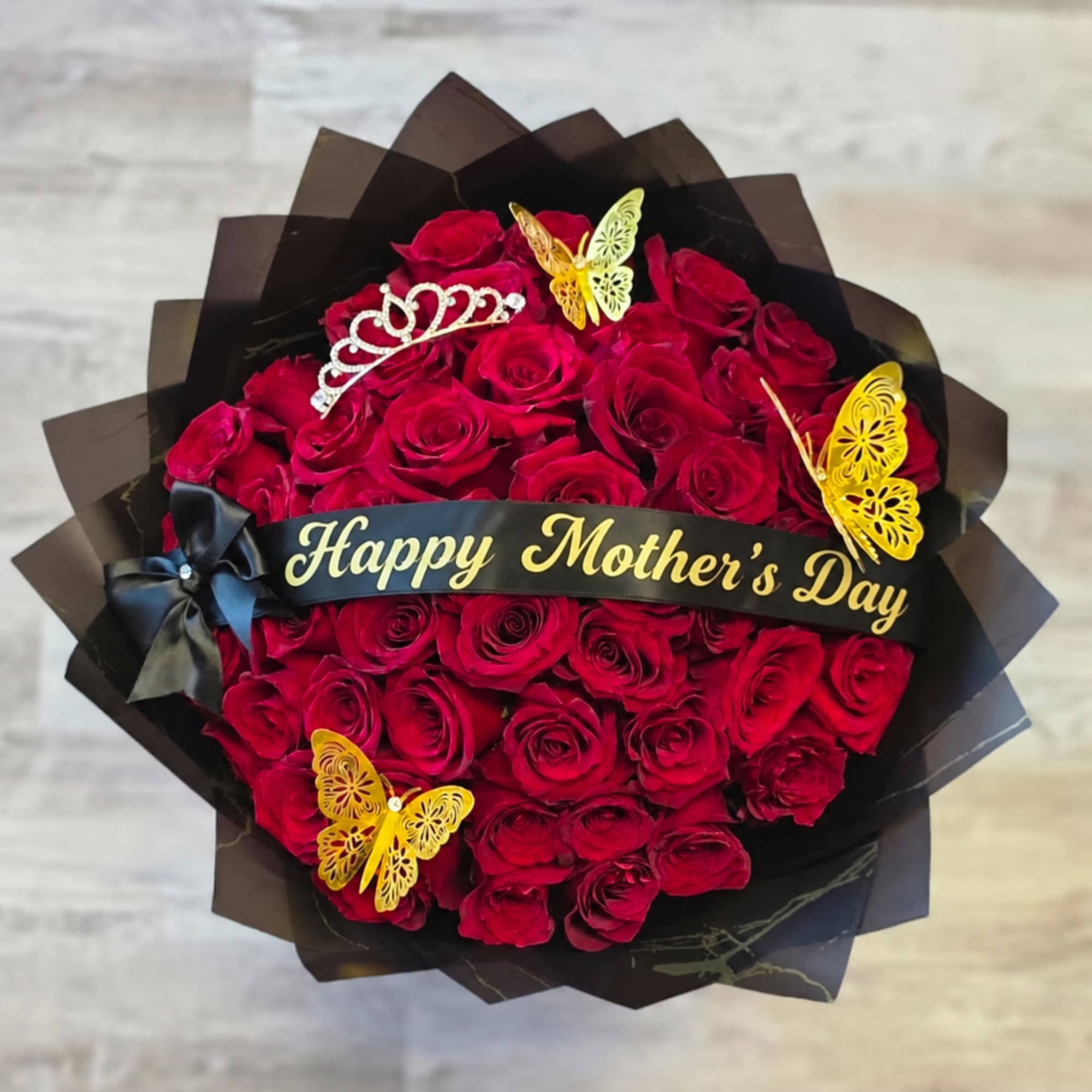 Our 25/50/75 Stem Rose Bouquet with custom banner, crown and butterflies delivers