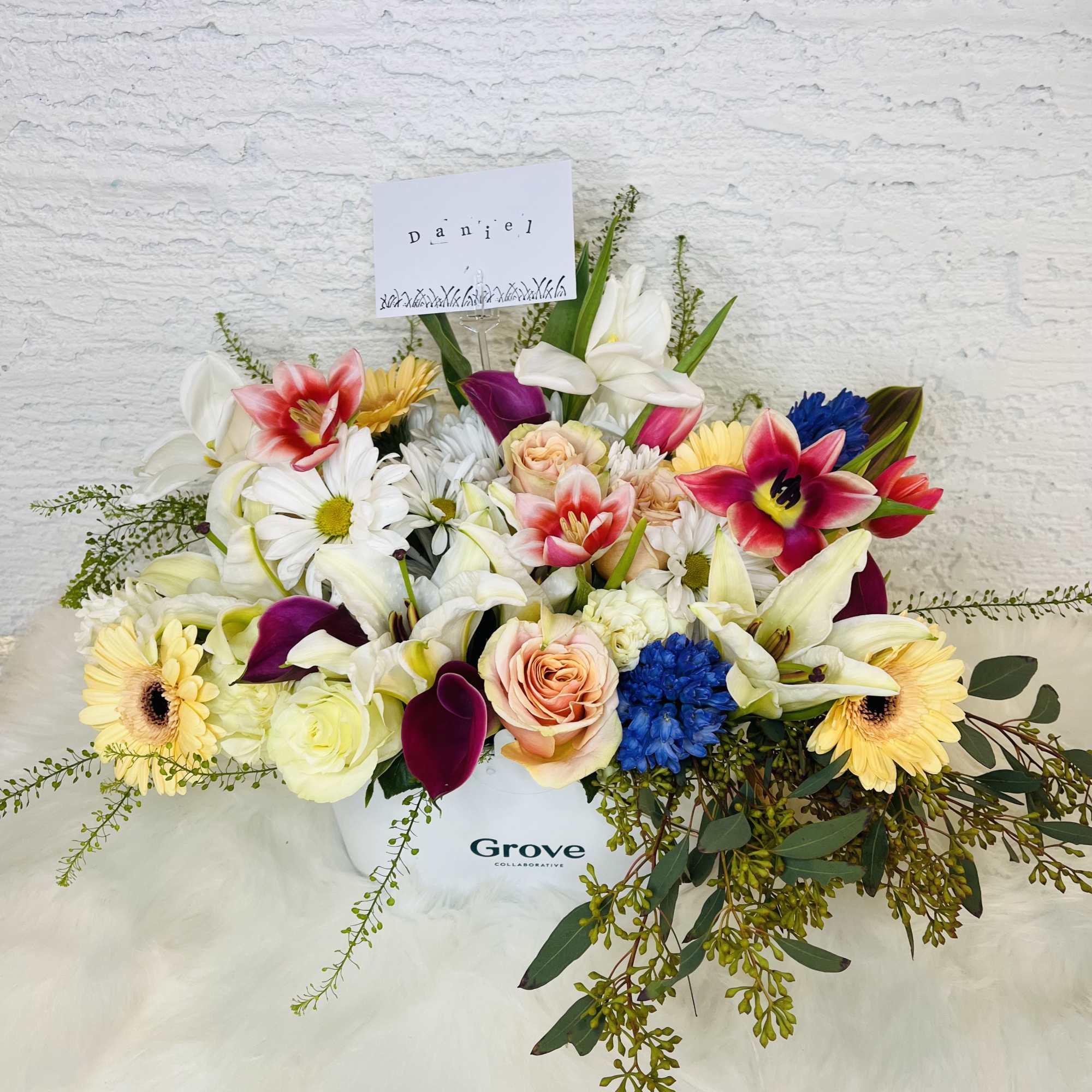 Mixed bouquet in a white box with lilies, roses, gerberas, and calla lilies