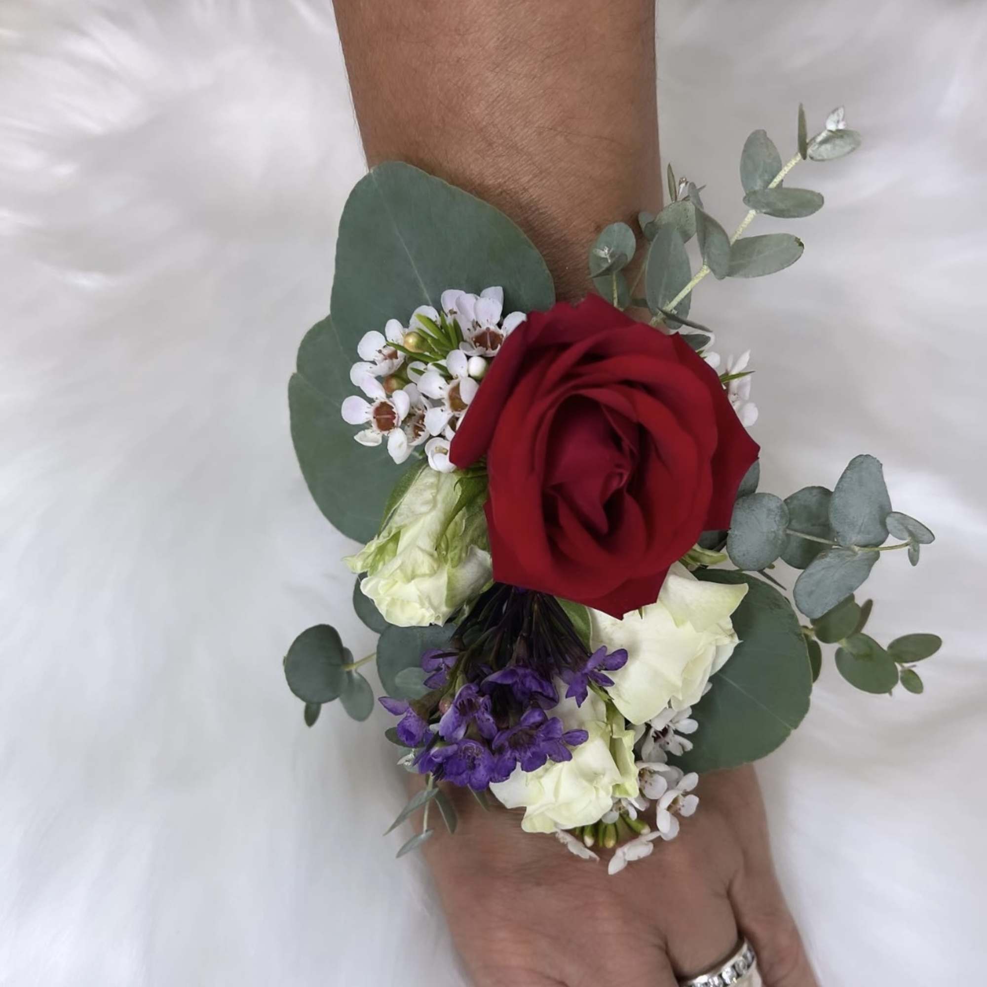 Red rose wrist corsage with white and purple flowers