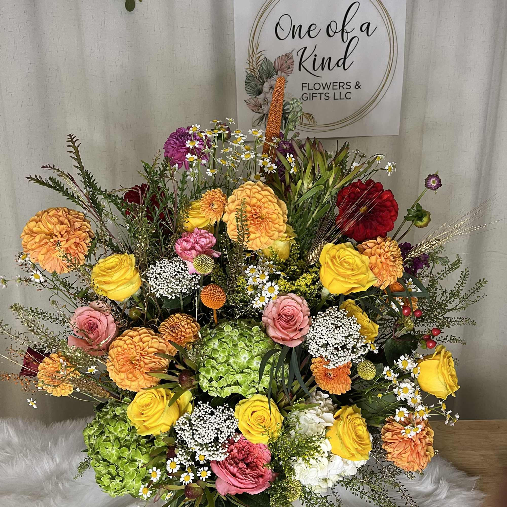 Large mixed bouquet with yellow and pink roses in a low container