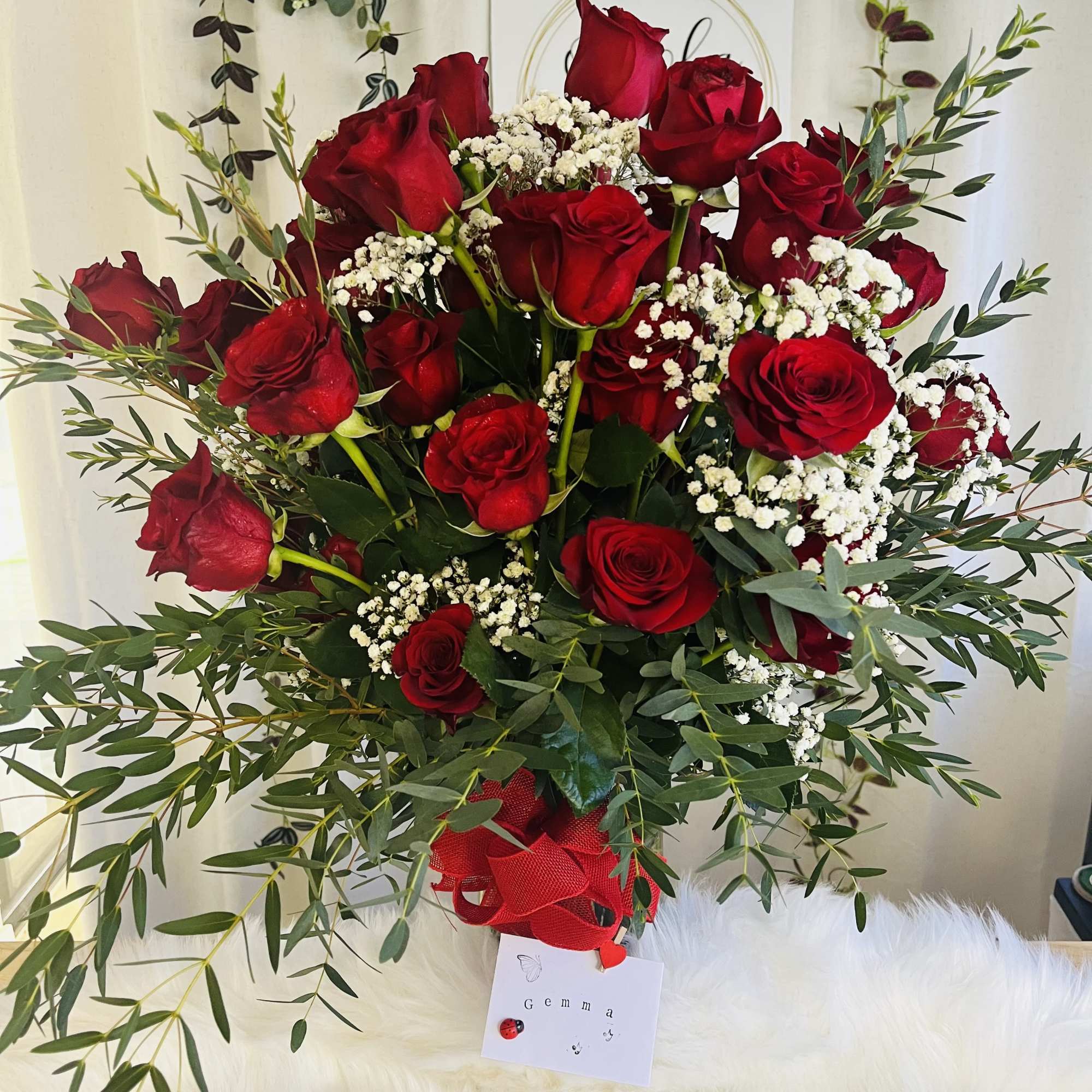 Bouquet of red roses with white baby's breath and greenery