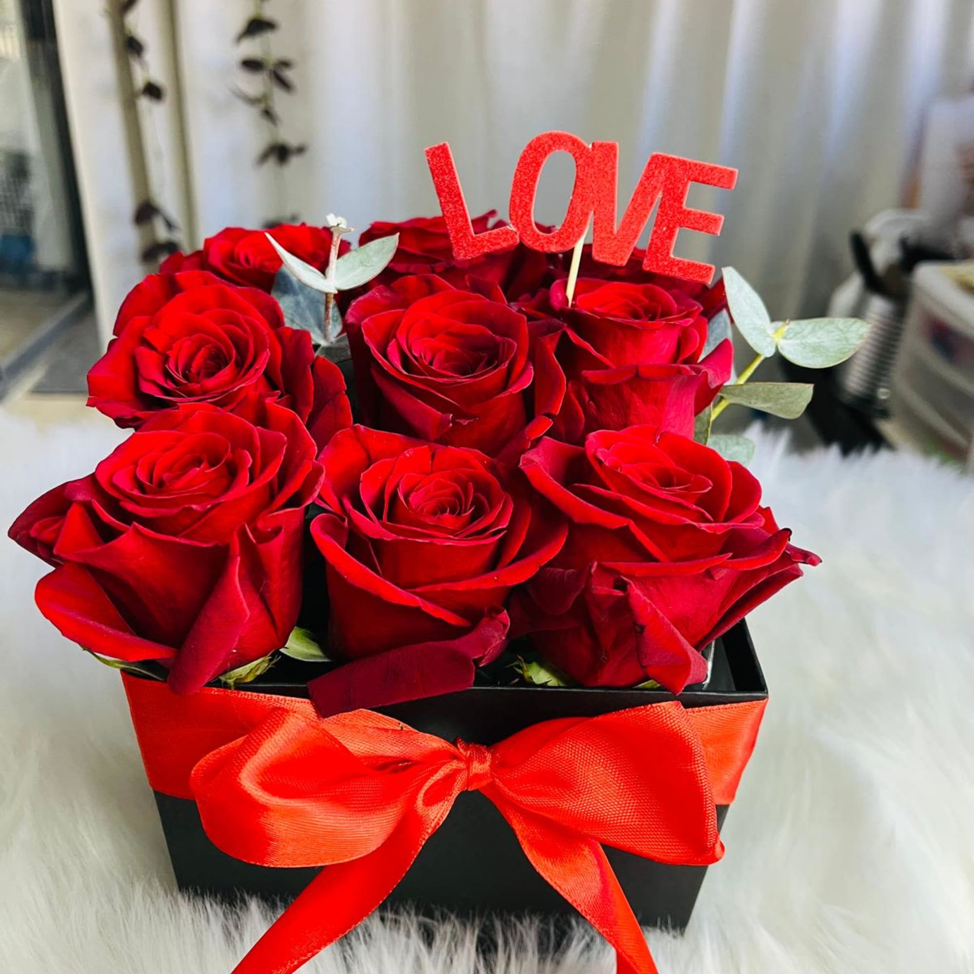 Red roses in a black box with a red ribbon and LOVE topper, photo 2 of 2