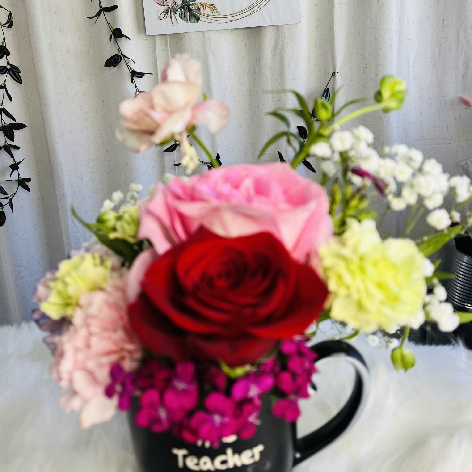 Mixed flower bouquet in a black teacher mug