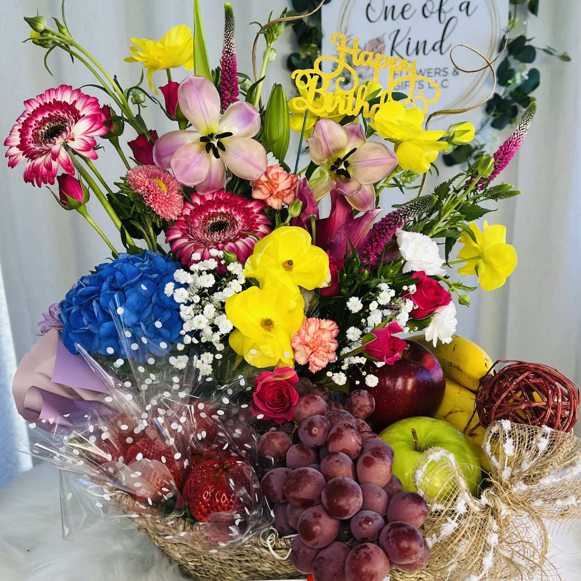 Mixed flower basket with fruit, balloons, and a Happy Birthday topper