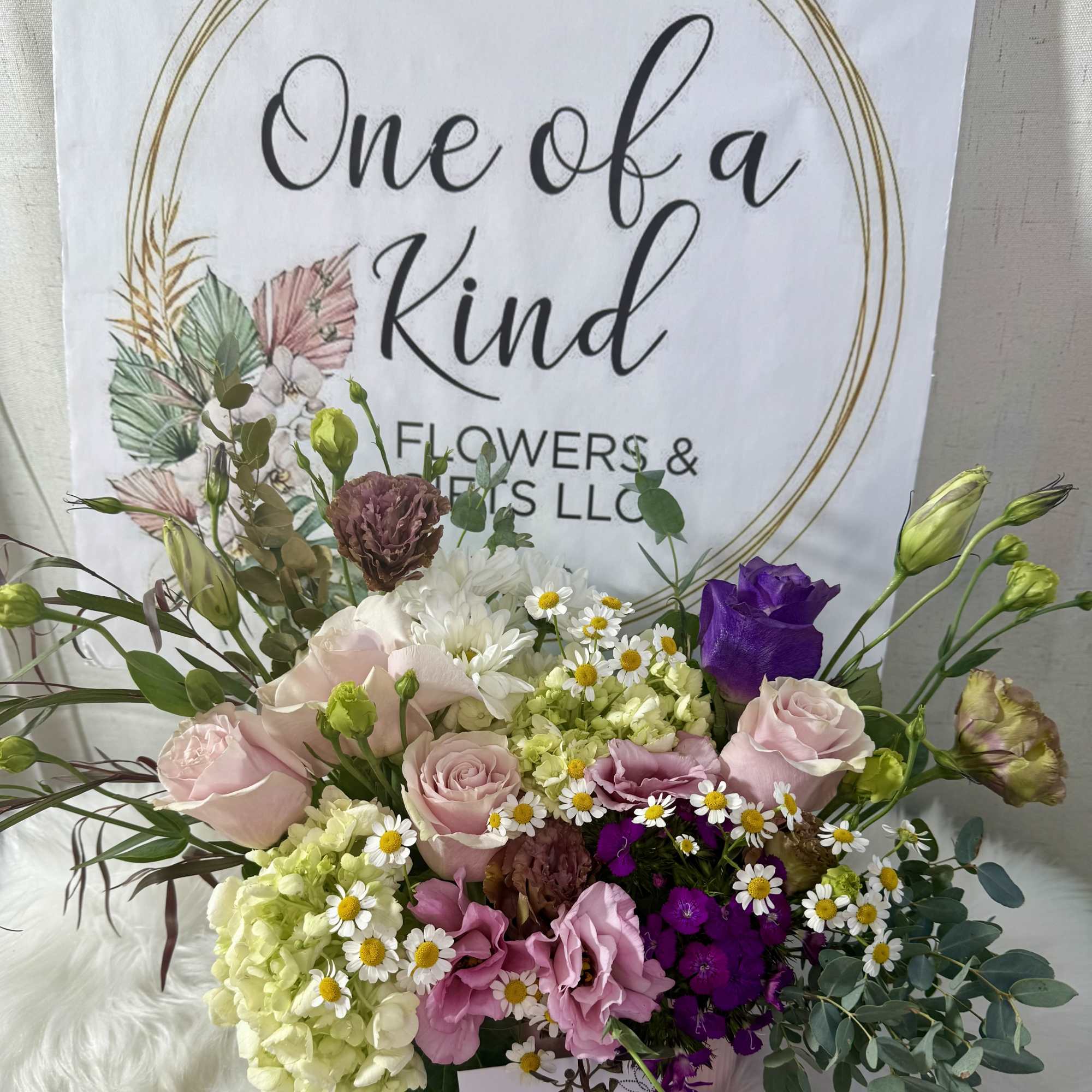 Mixed bouquet of pink, purple, white, and green flowers