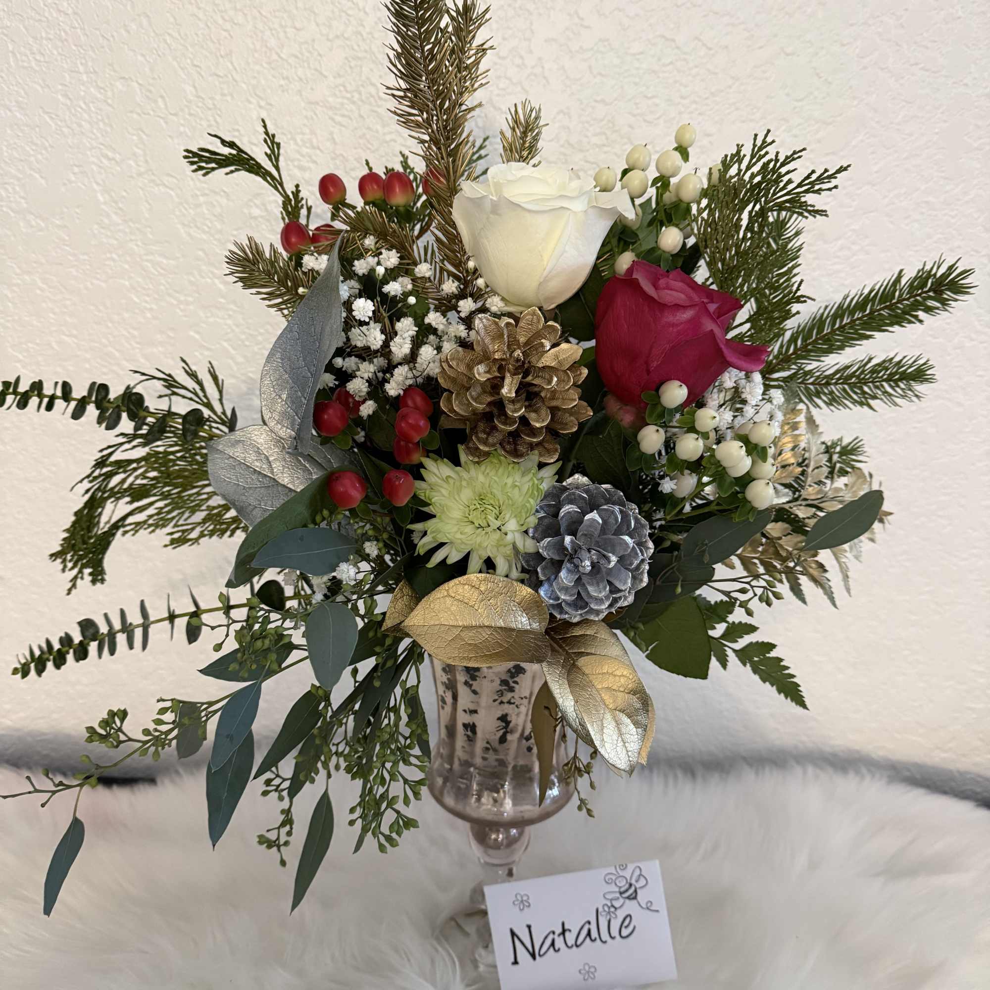 Holiday bouquet with red and white roses in a glass vase