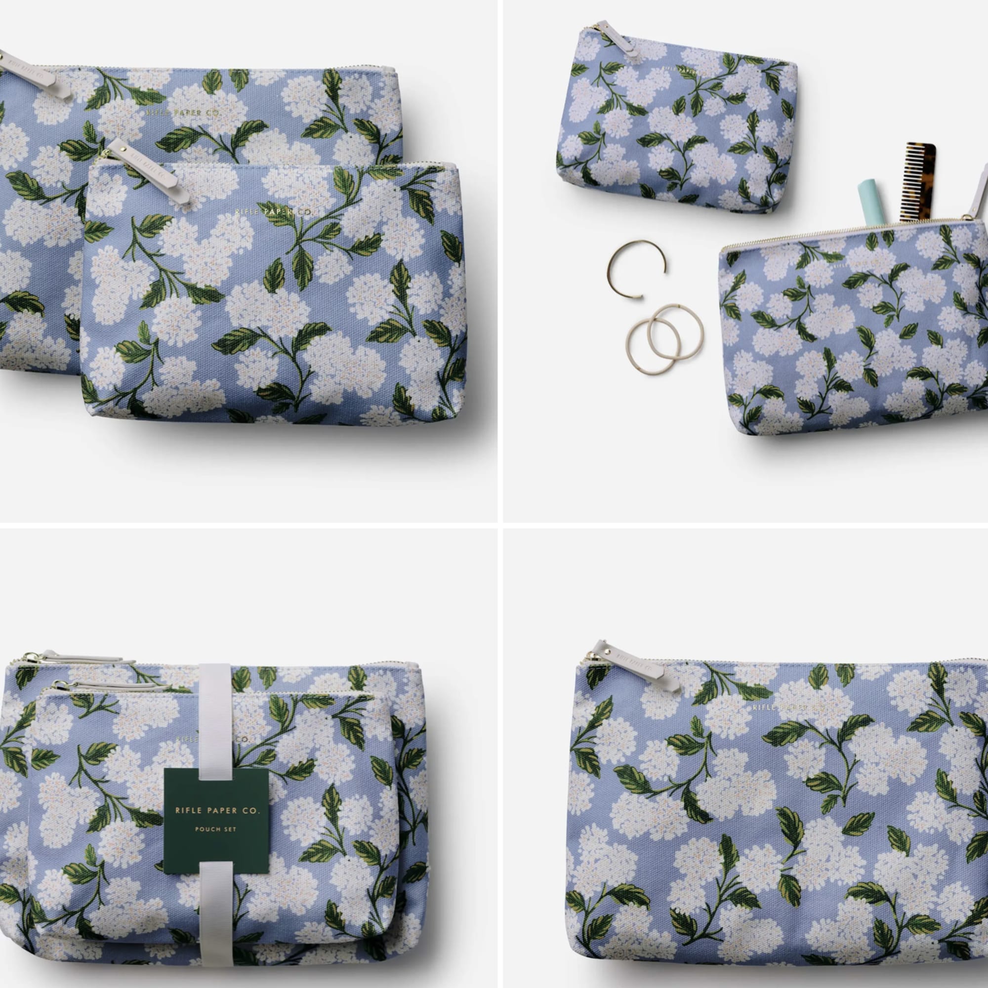 Floral-print zip pouch set in light blue with white blossoms and green leaves.