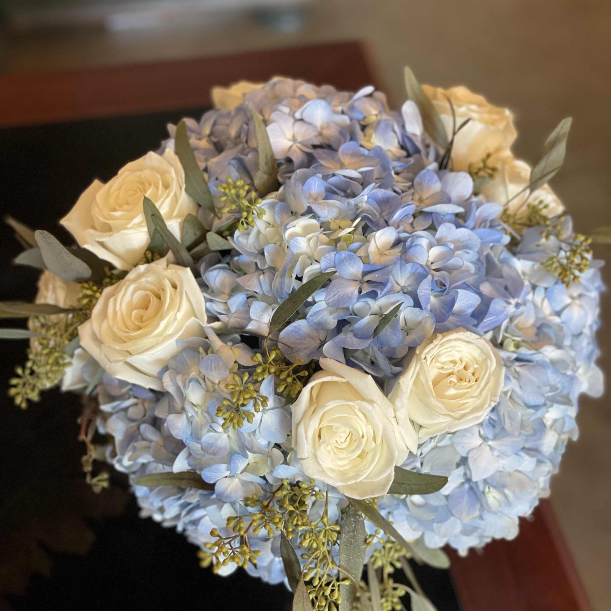 Bouquet of pale blue hydrangeas and cream roses