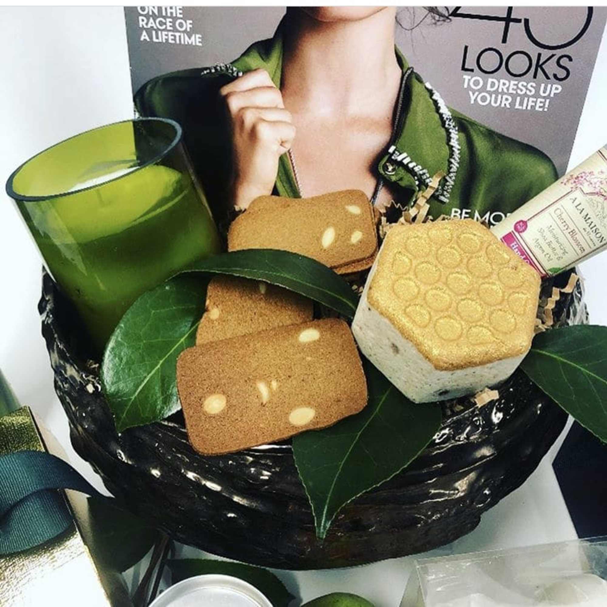 Gift basket with a green candle and assorted soaps