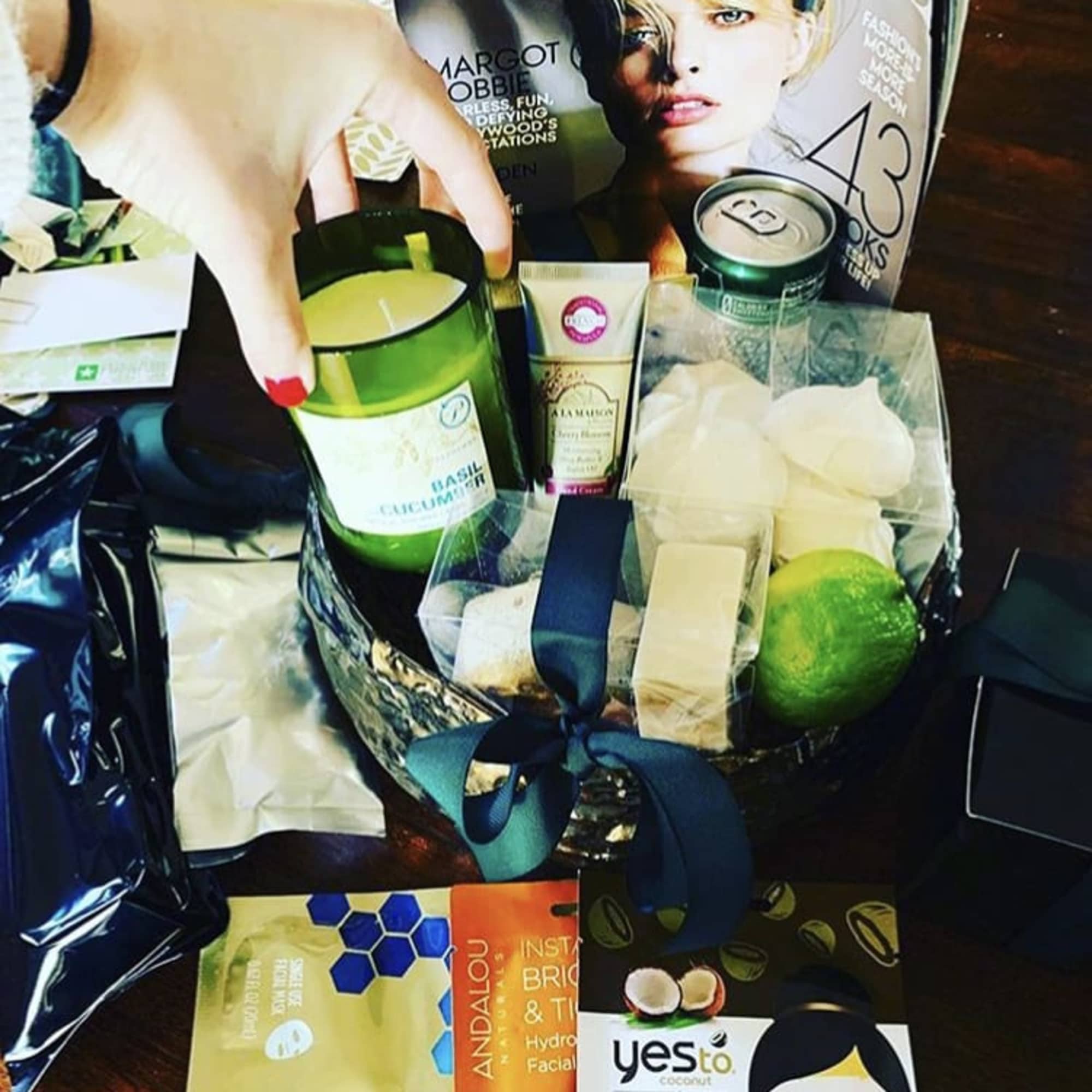Gift basket with candles, bath items, and face masks