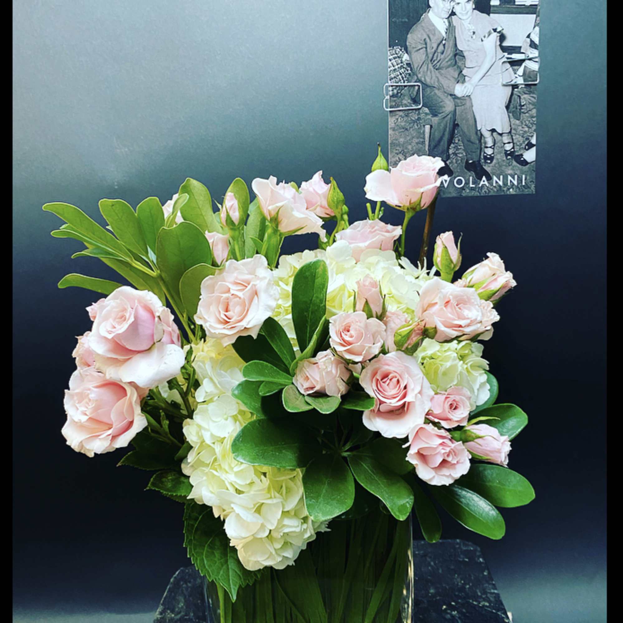 Pink roses and white hydrangeas in a clear glass vase