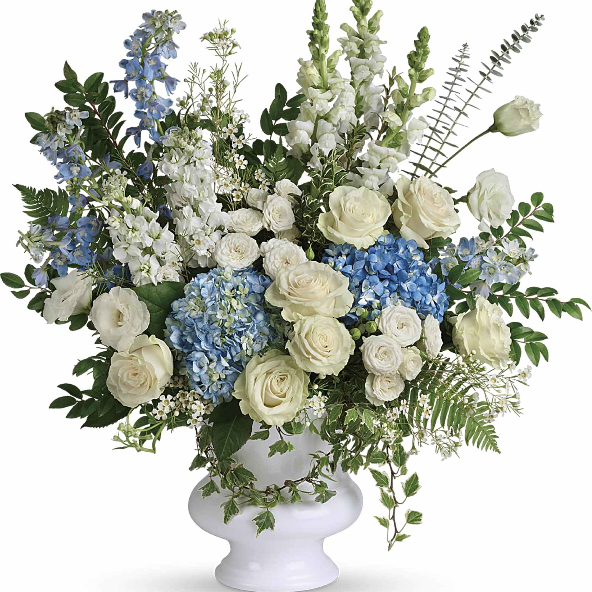 White and blue floral arrangement in a white vase