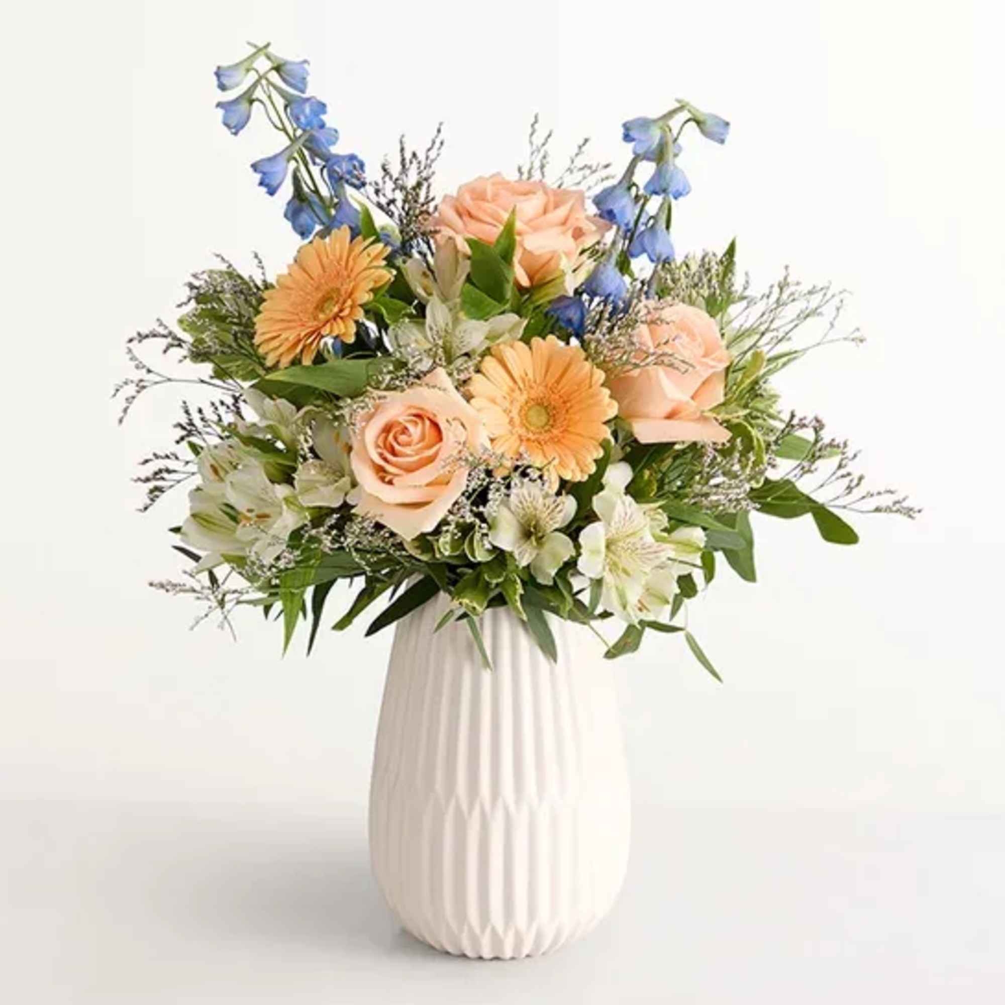  Our gathering of roses, Peruvian lilies, and other blooms evokes salt-kissed