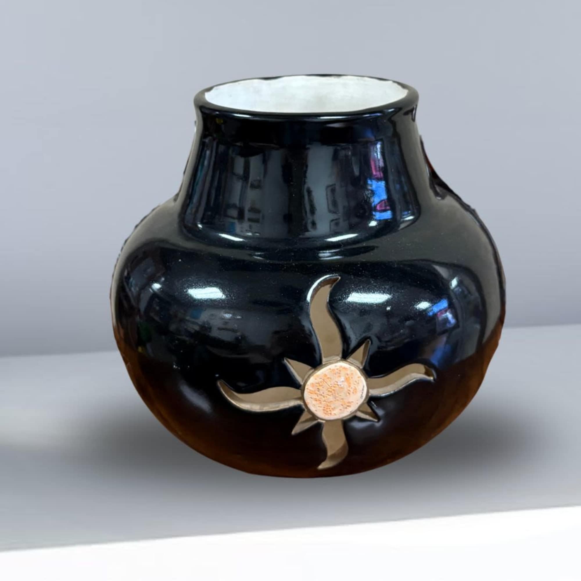Black ceramic vase with a small floral motif