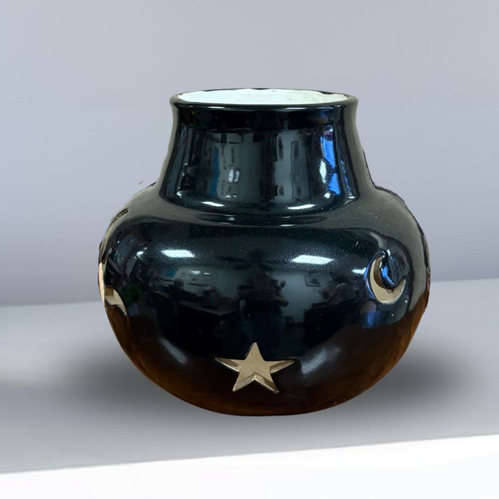 Black ceramic vase with gold moon and star accents
