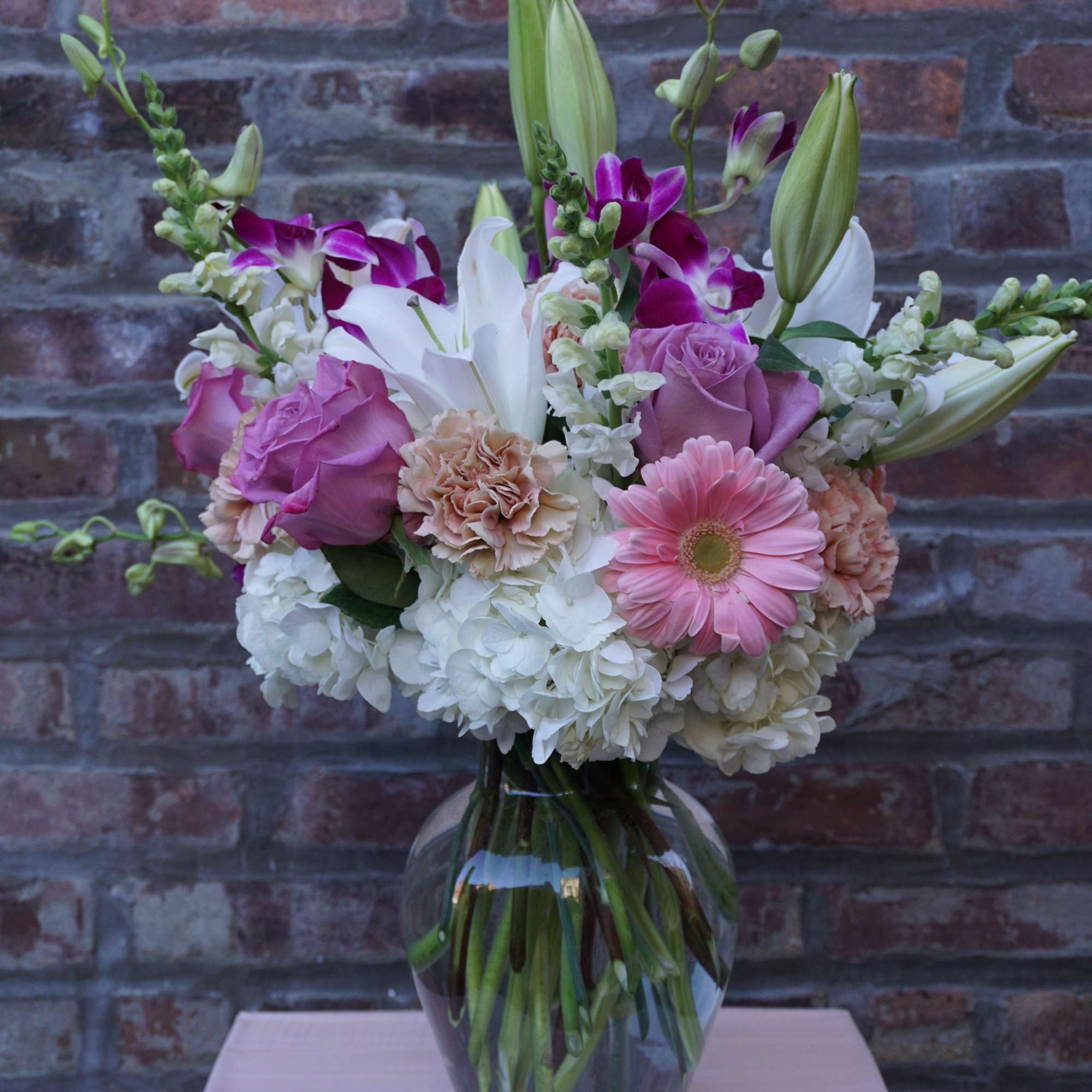 Pink and white mixed bouquet in a clear glass vase