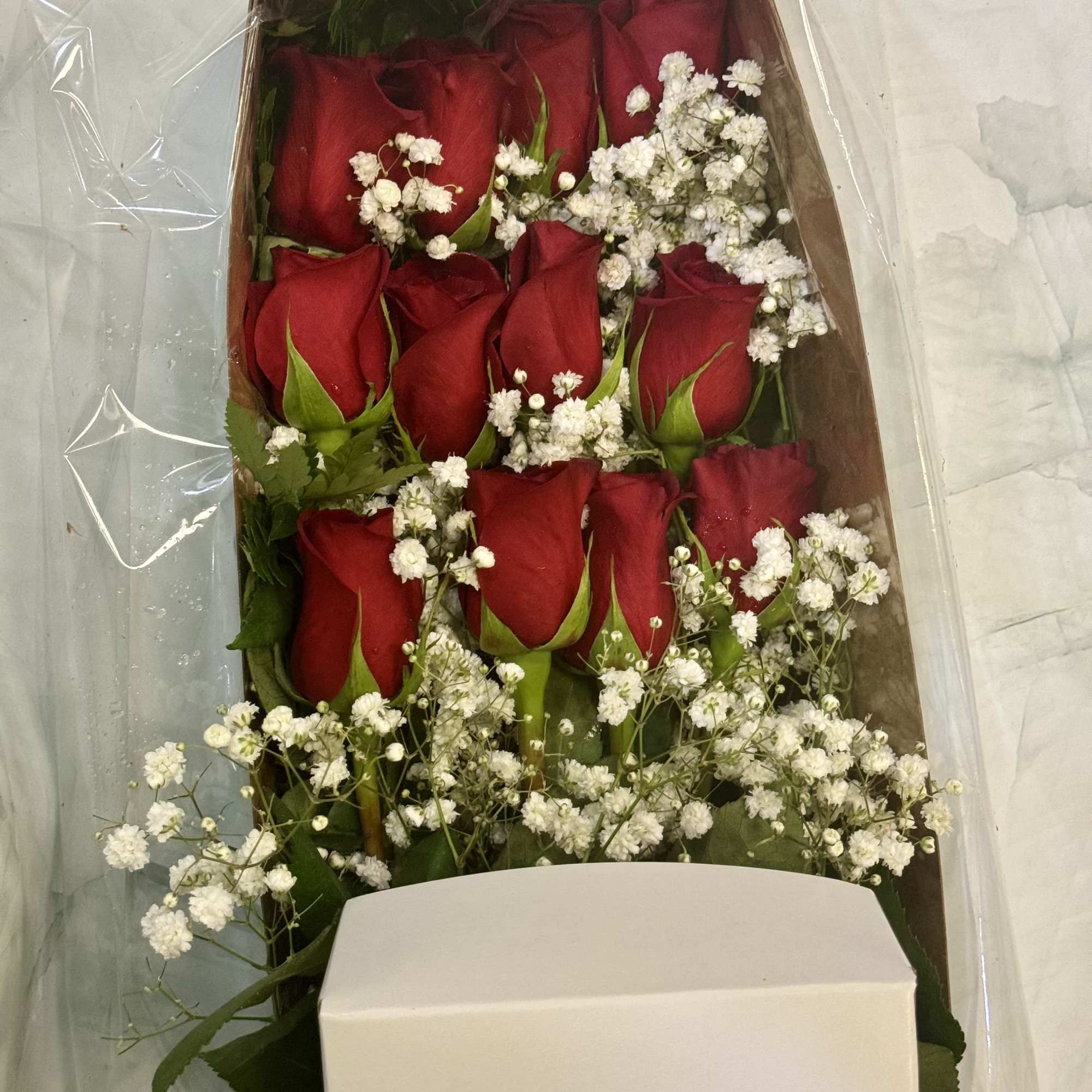 Boxed bouquet of red roses with white baby's breath