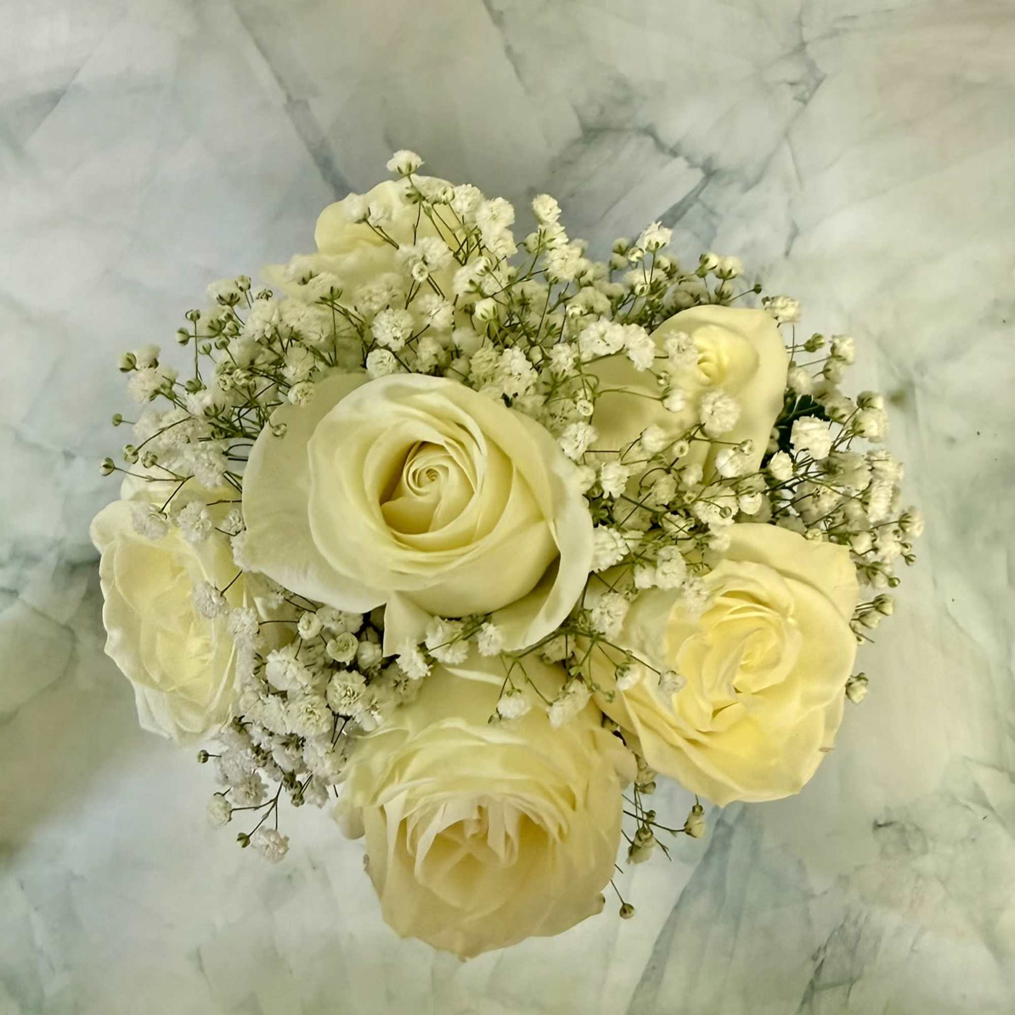 White roses gathered into a compact, rounded hand-tied bouquet create an immediate, photo 2 of 2