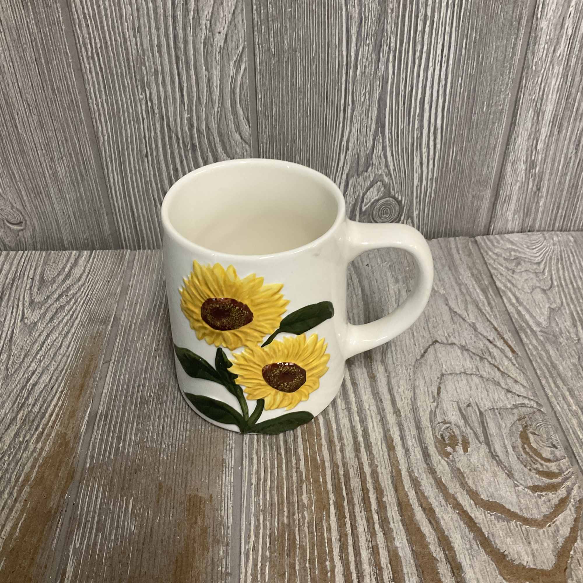 White ceramic mug with painted sunflowers