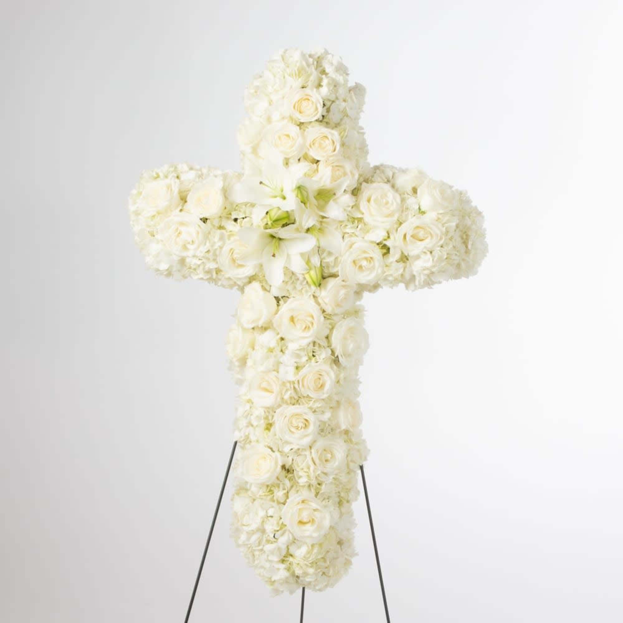 White floral cross on a stand