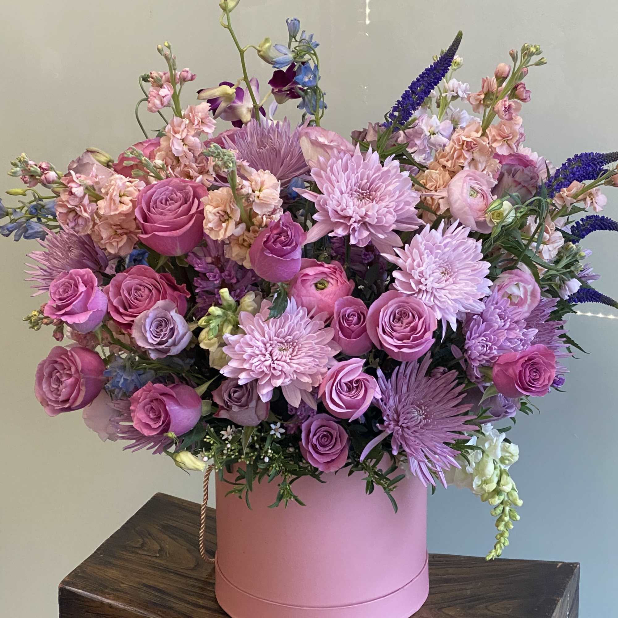 Pink and lavender bouquet in a round pink box