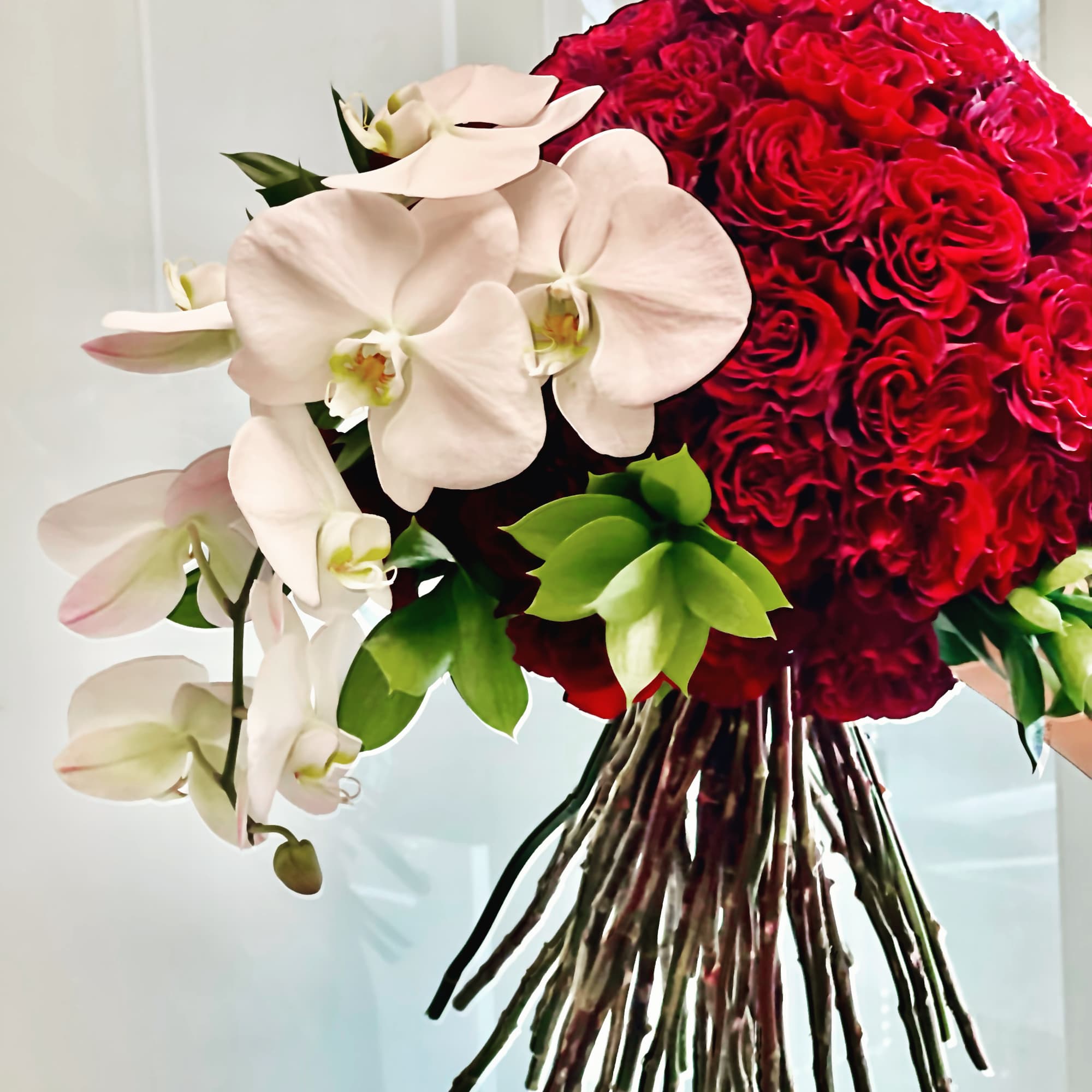 Red rose bouquet with white orchids