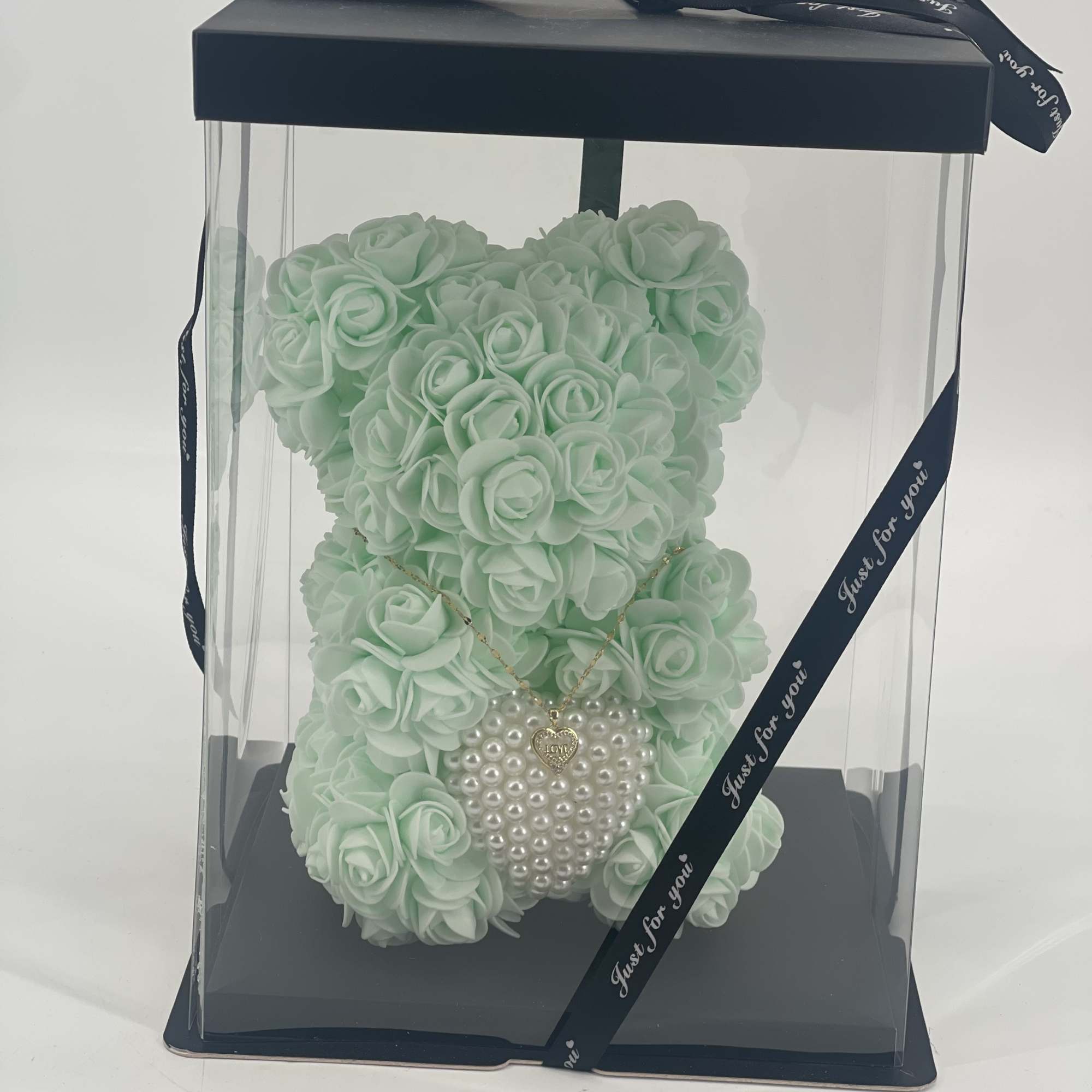 Mint green rose teddy bear in a clear gift box with a ribbon