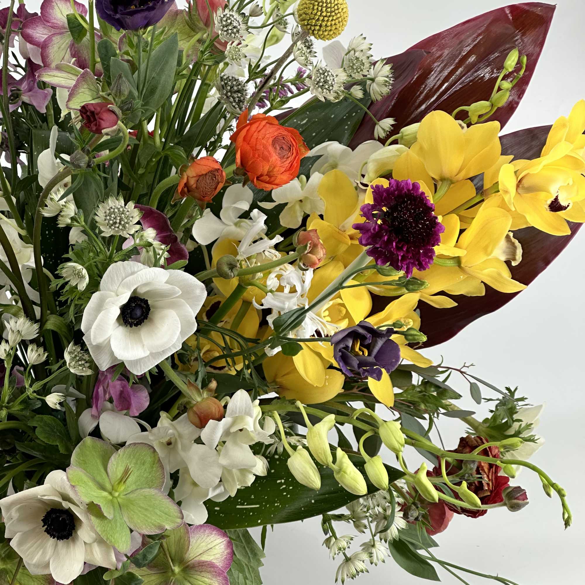 Mixed bouquet with yellow, white, purple, and orange flowers