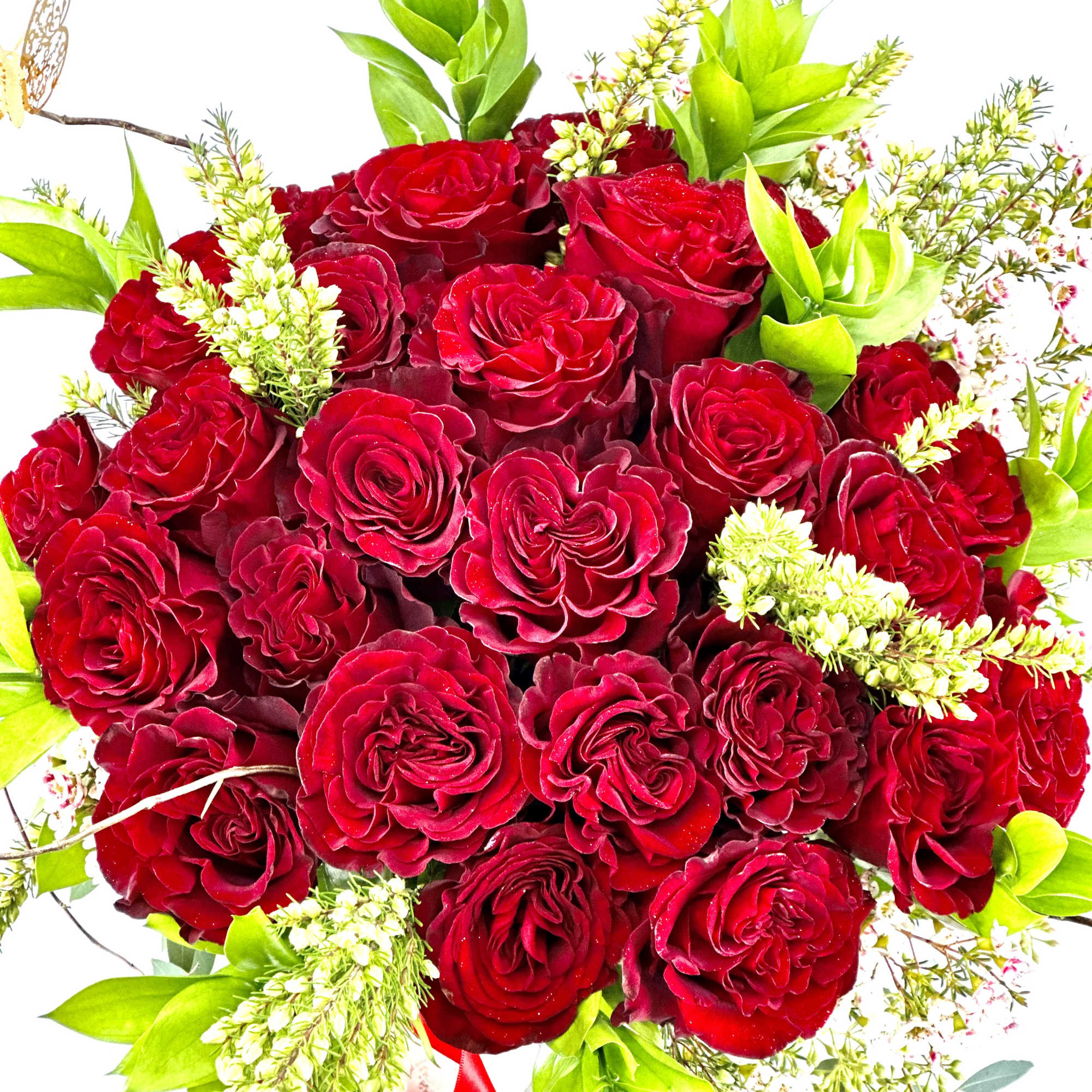 Bouquet of red roses with bright green foliage and small white filler flowers