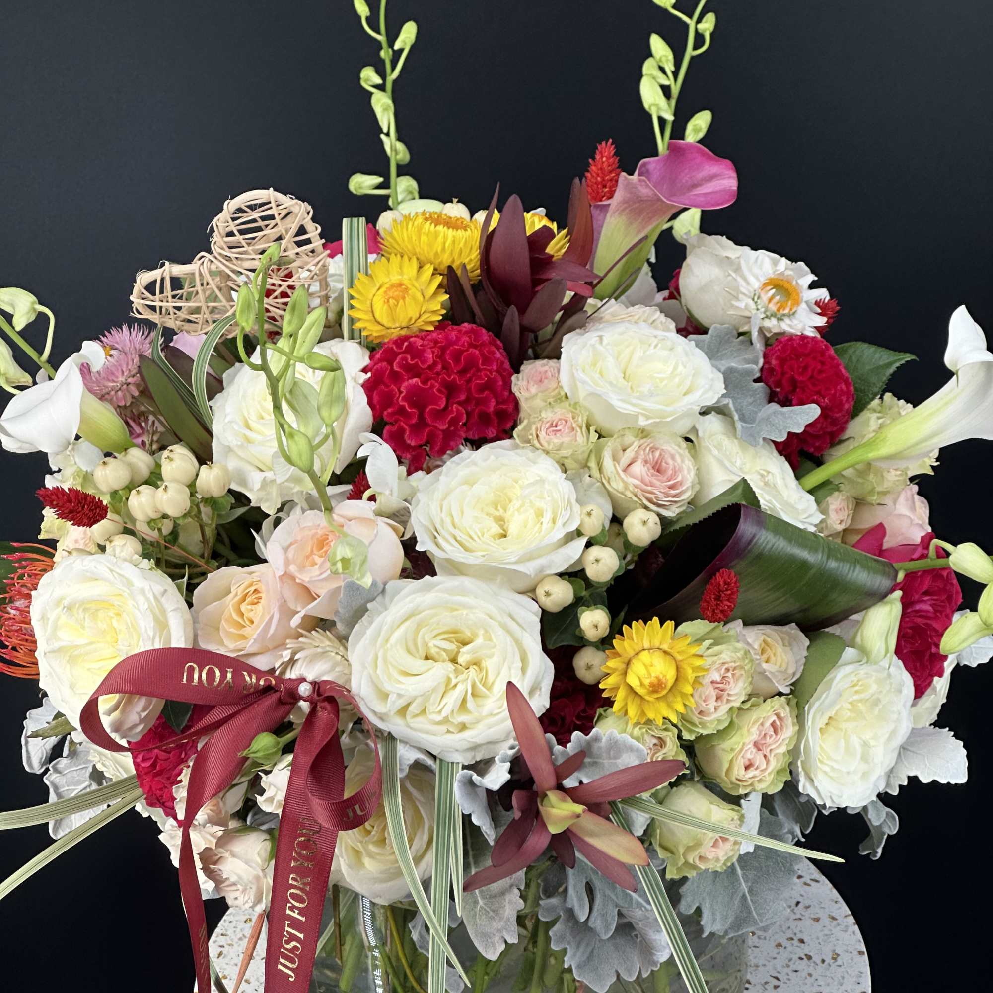 Mixed bouquet in a glass vase with white, pink, and yellow flowers