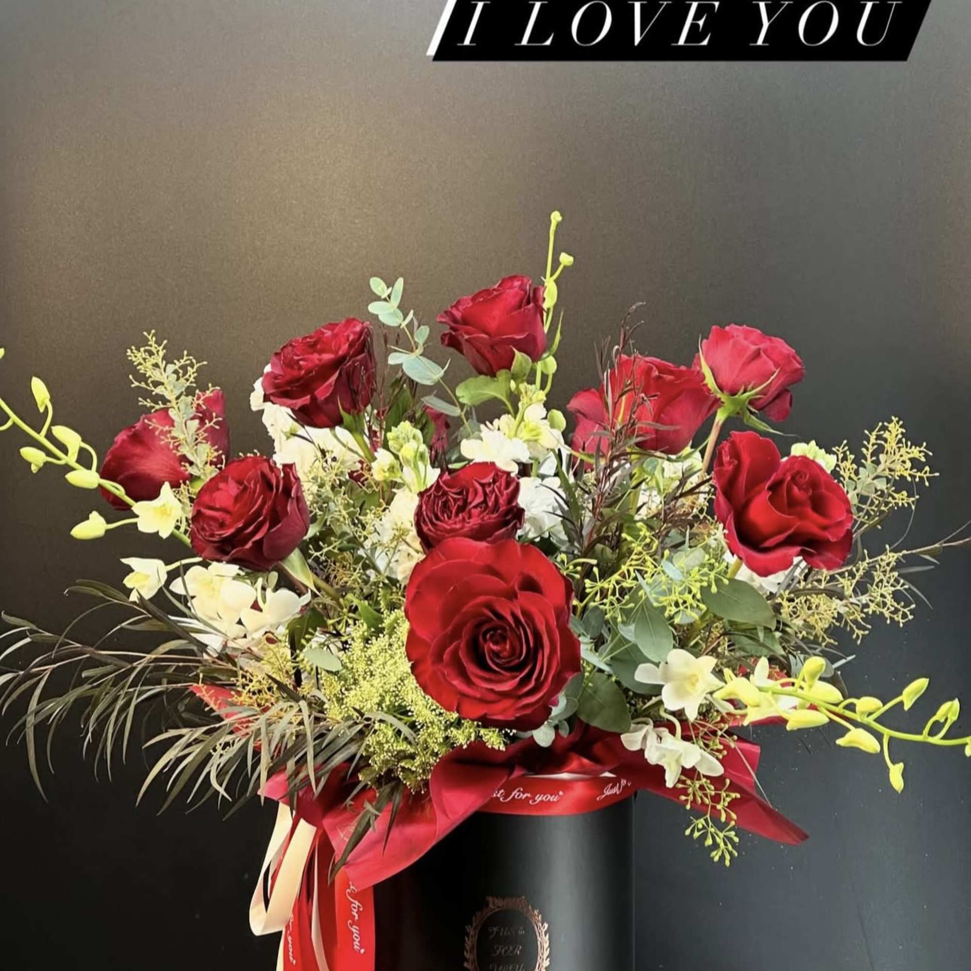 A striking arrangement of velvety red  hearts roses ,artfully composed with