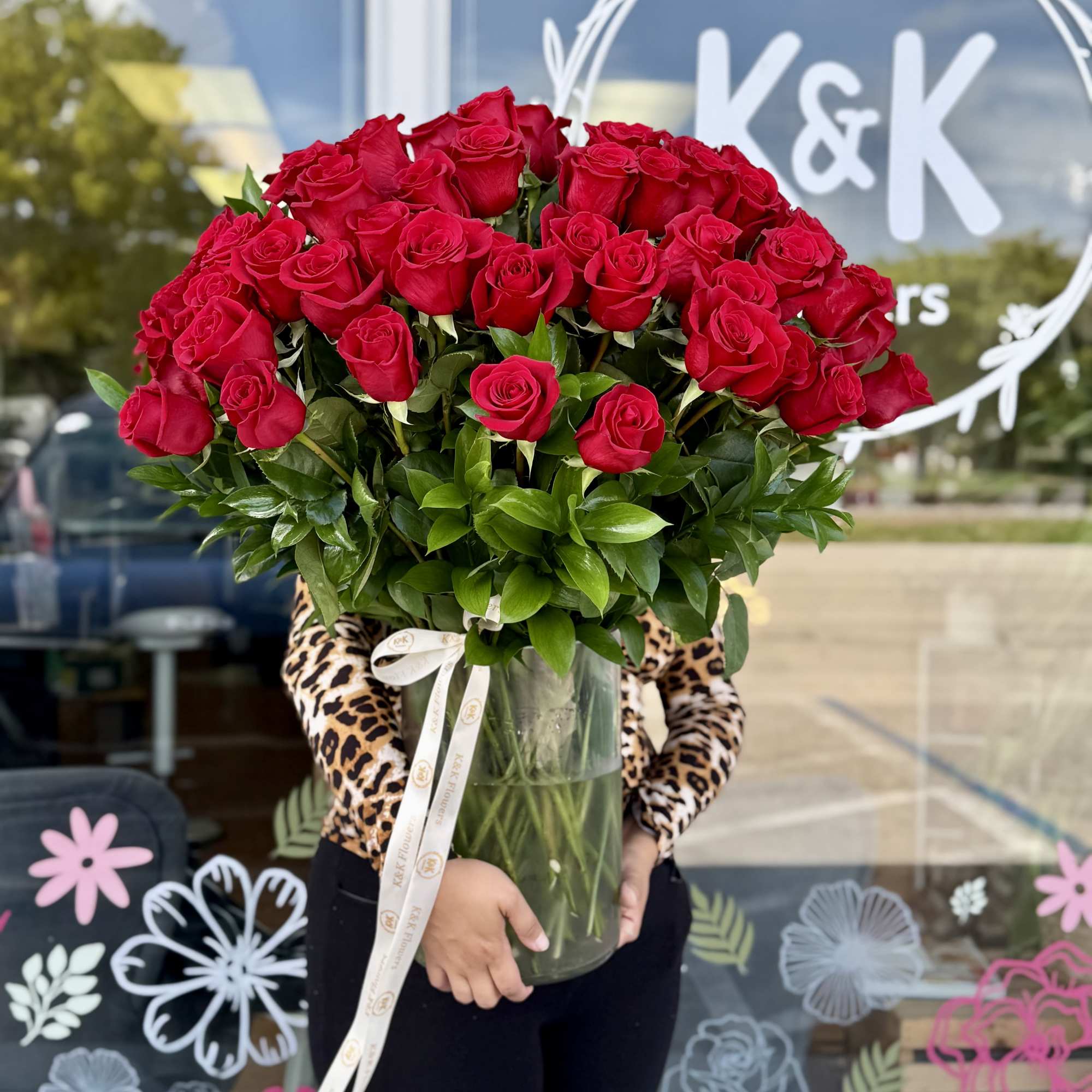 Large bouquet of red roses in a clear glass vase