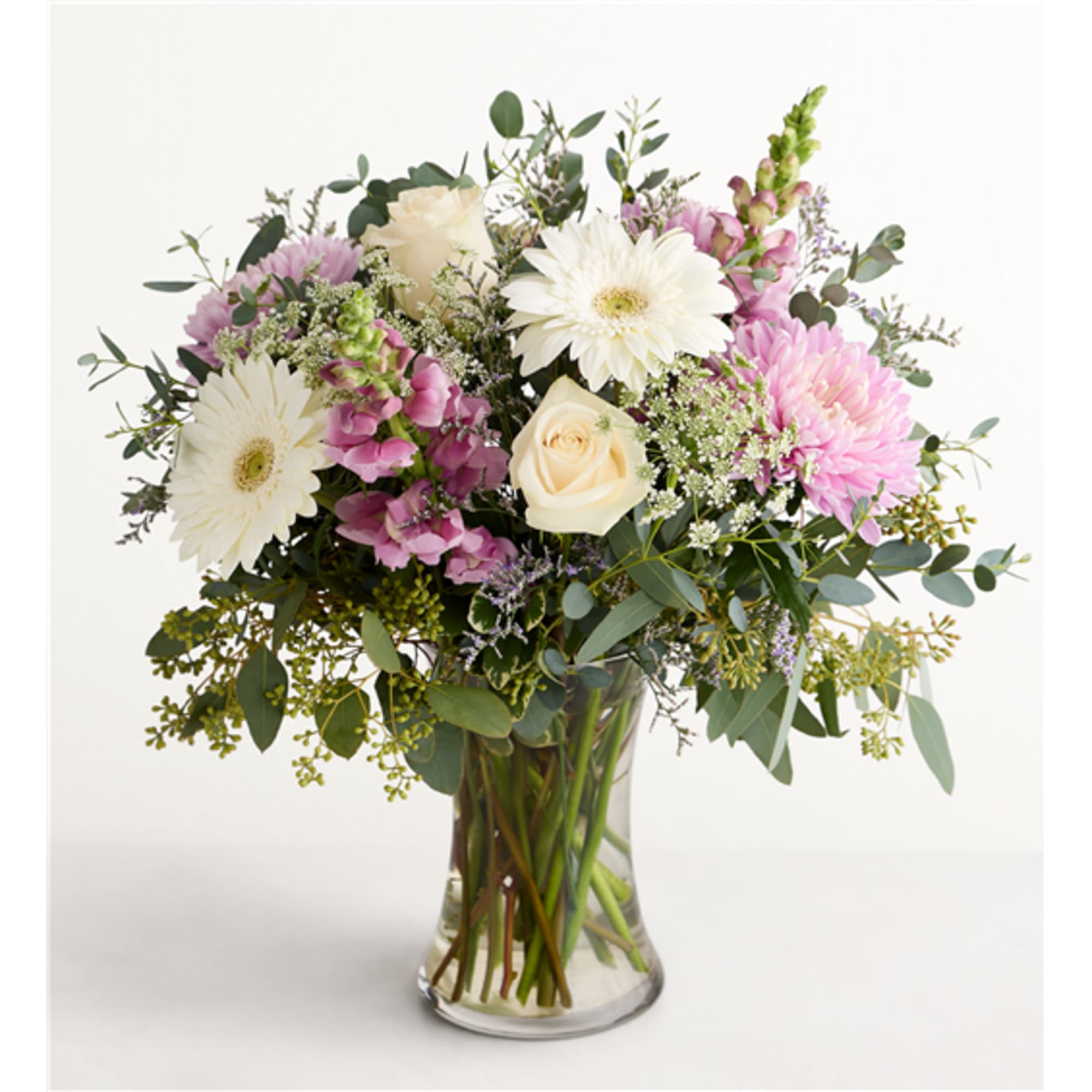 Bouquet of white and pink flowers in a clear glass vase