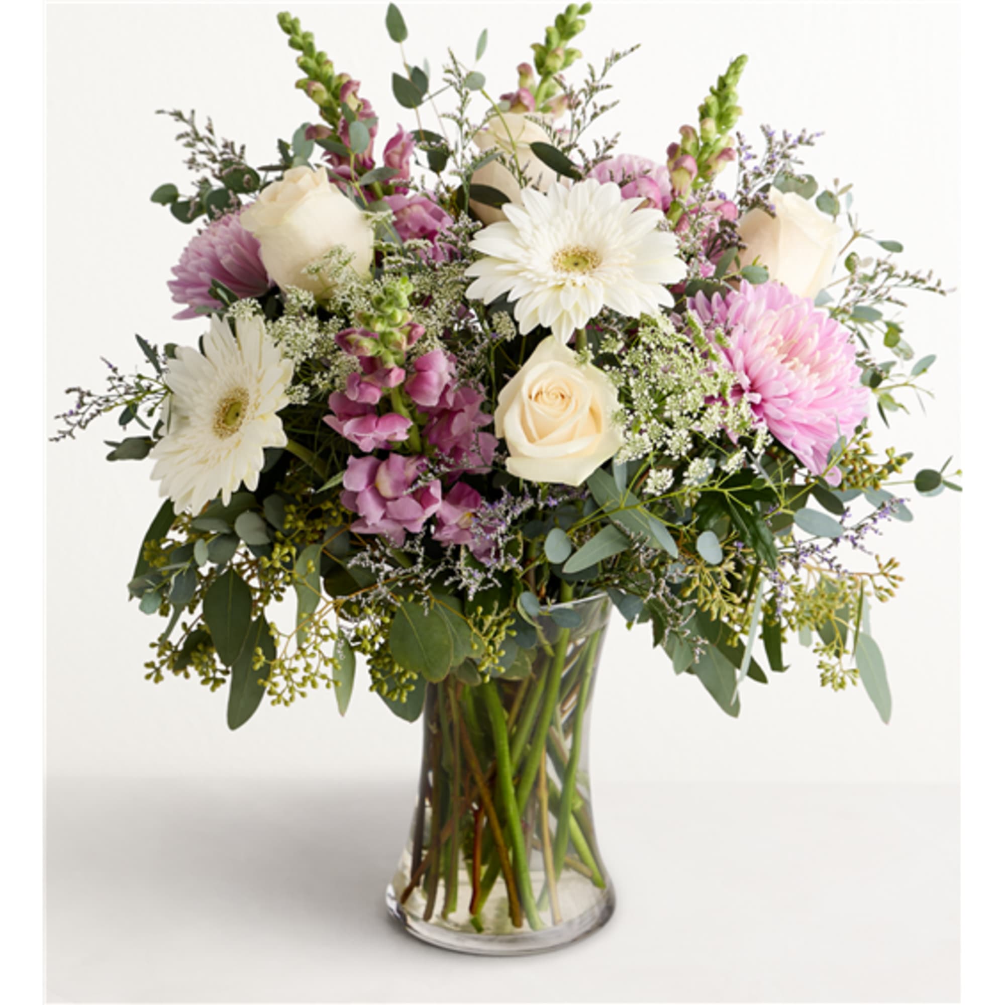 Bouquet of white and pink flowers in a clear glass vase