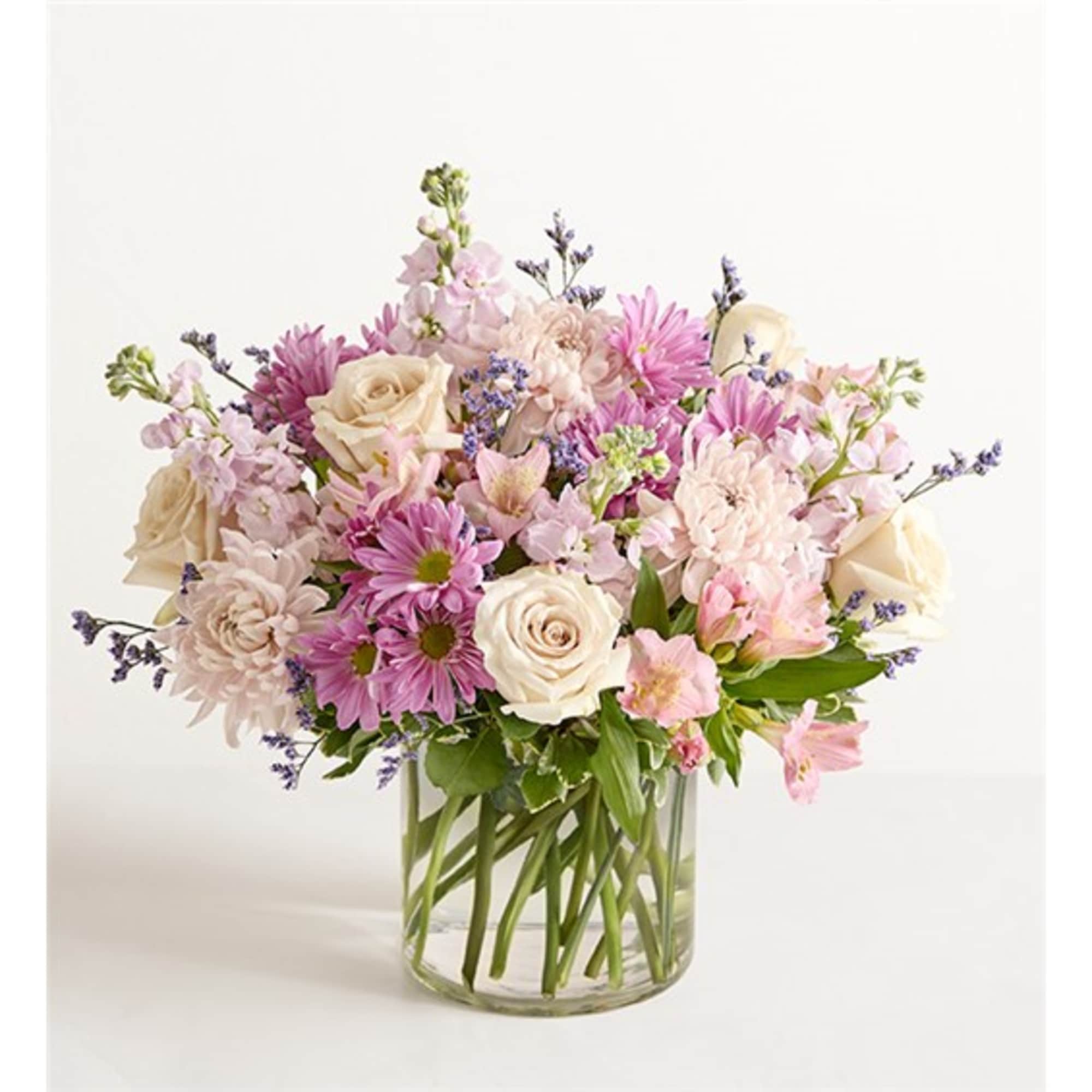 Bouquet of pink and cream flowers in a clear glass vase