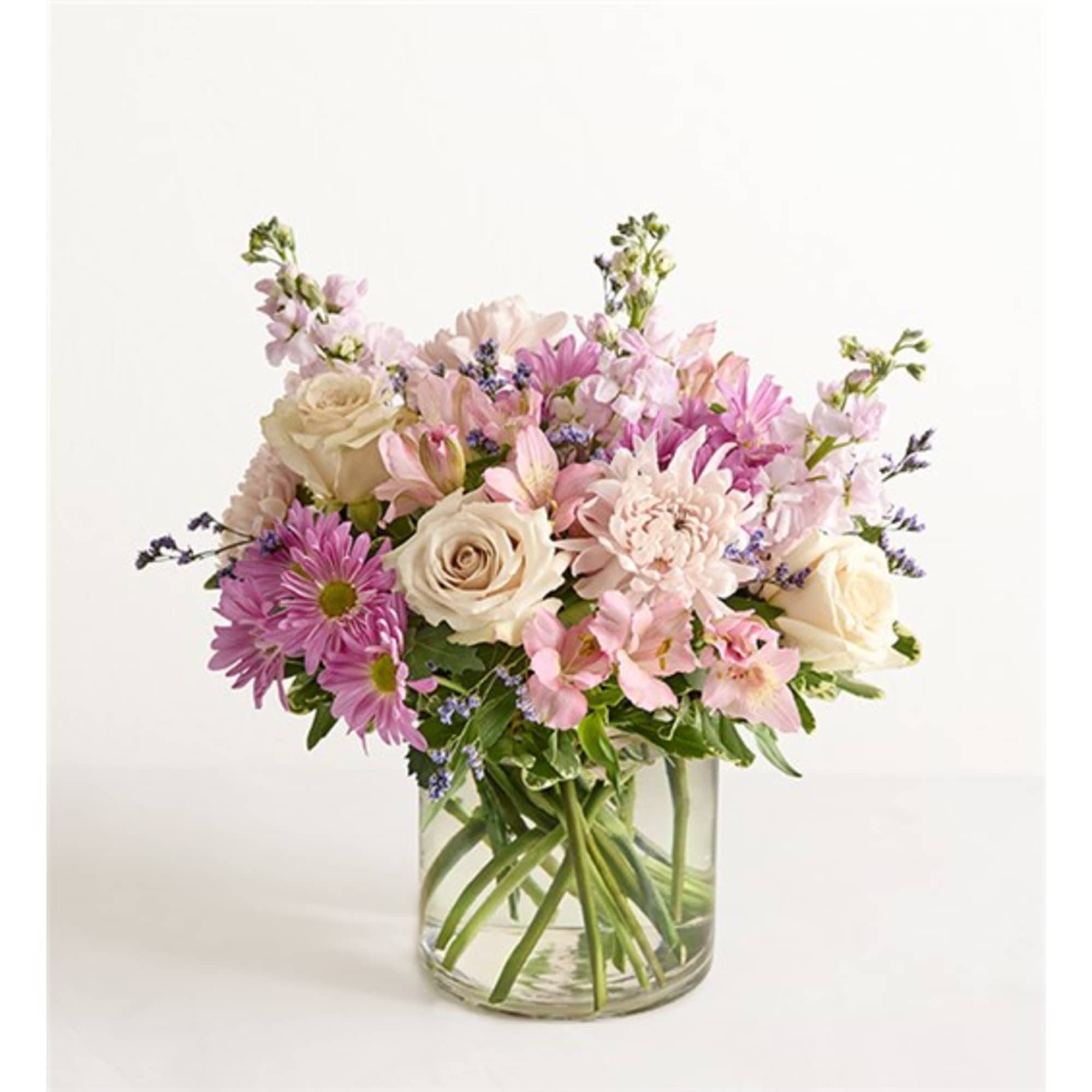 Pink and cream mixed bouquet in a clear glass vase