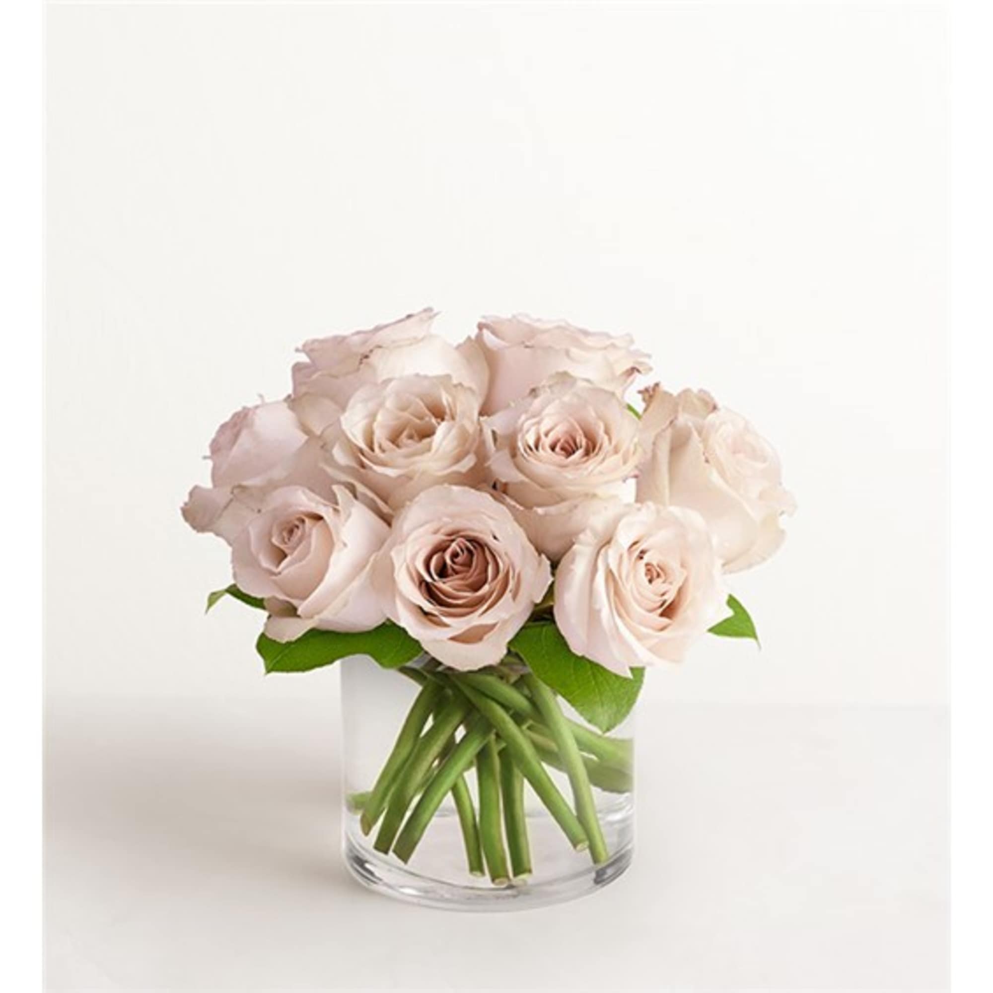 Pale blush roses arranged in a clear glass vase