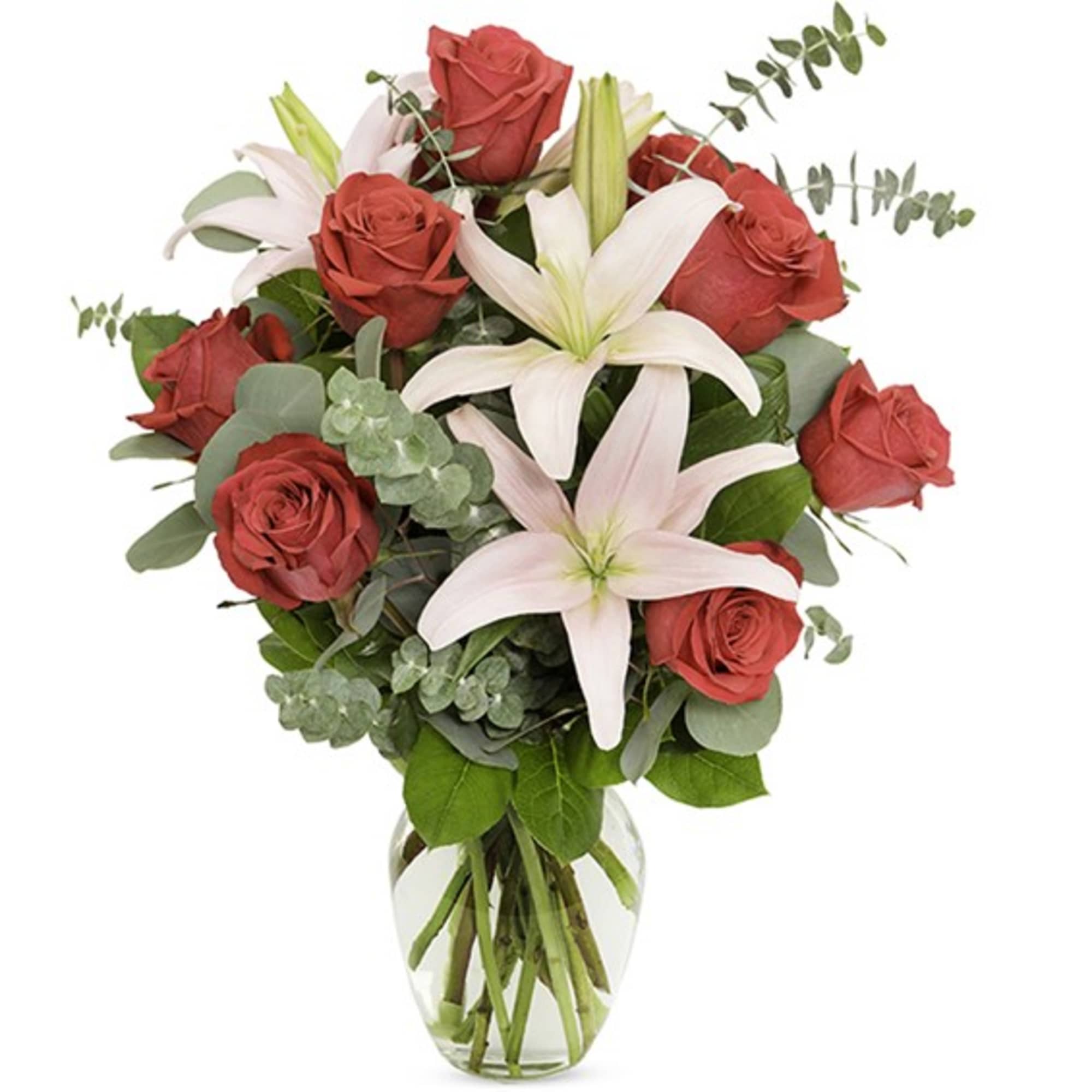 Bouquet of red roses and white lilies in a clear glass vase