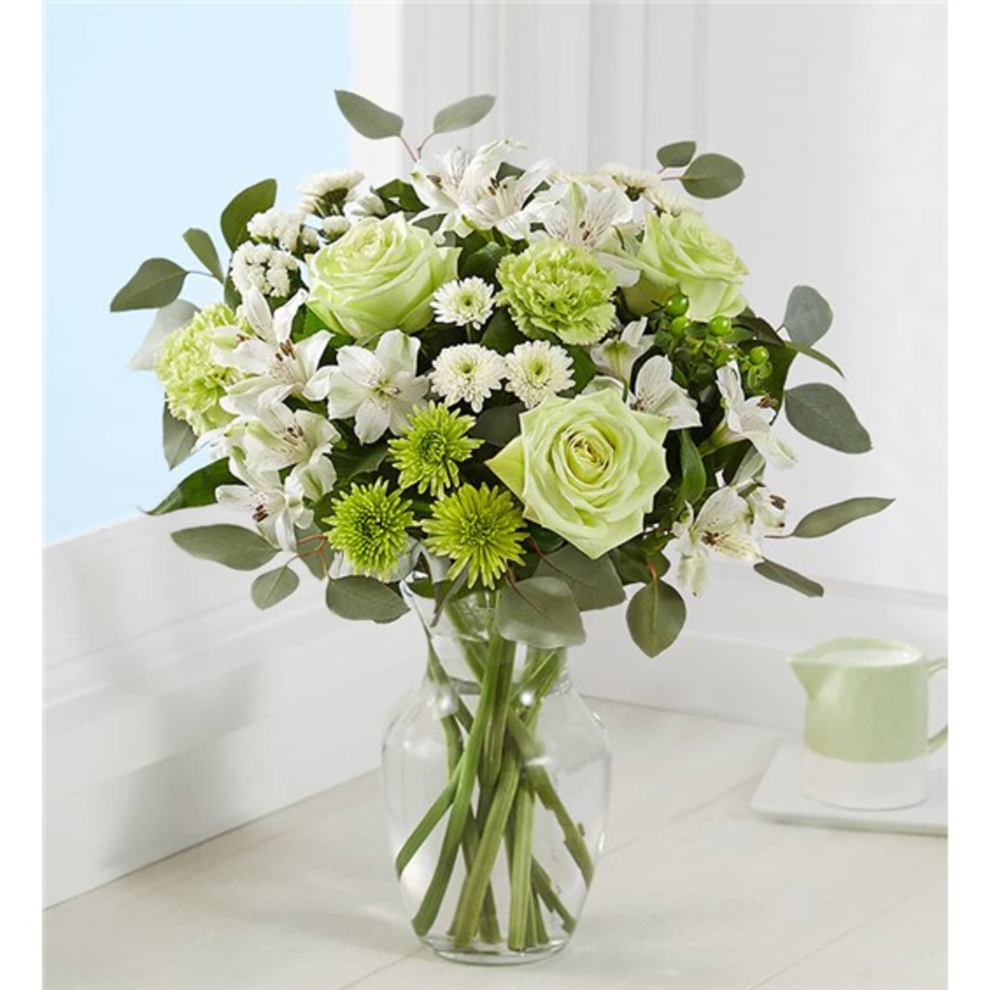 Bouquet of white and green flowers in a clear glass vase